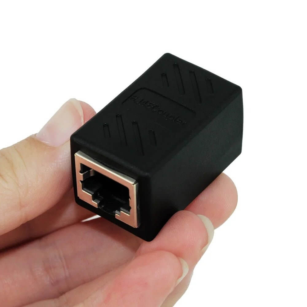 RJ45 female to female coupler adapter in hand, black 8P8C network extender for Ethernet cable connections.
