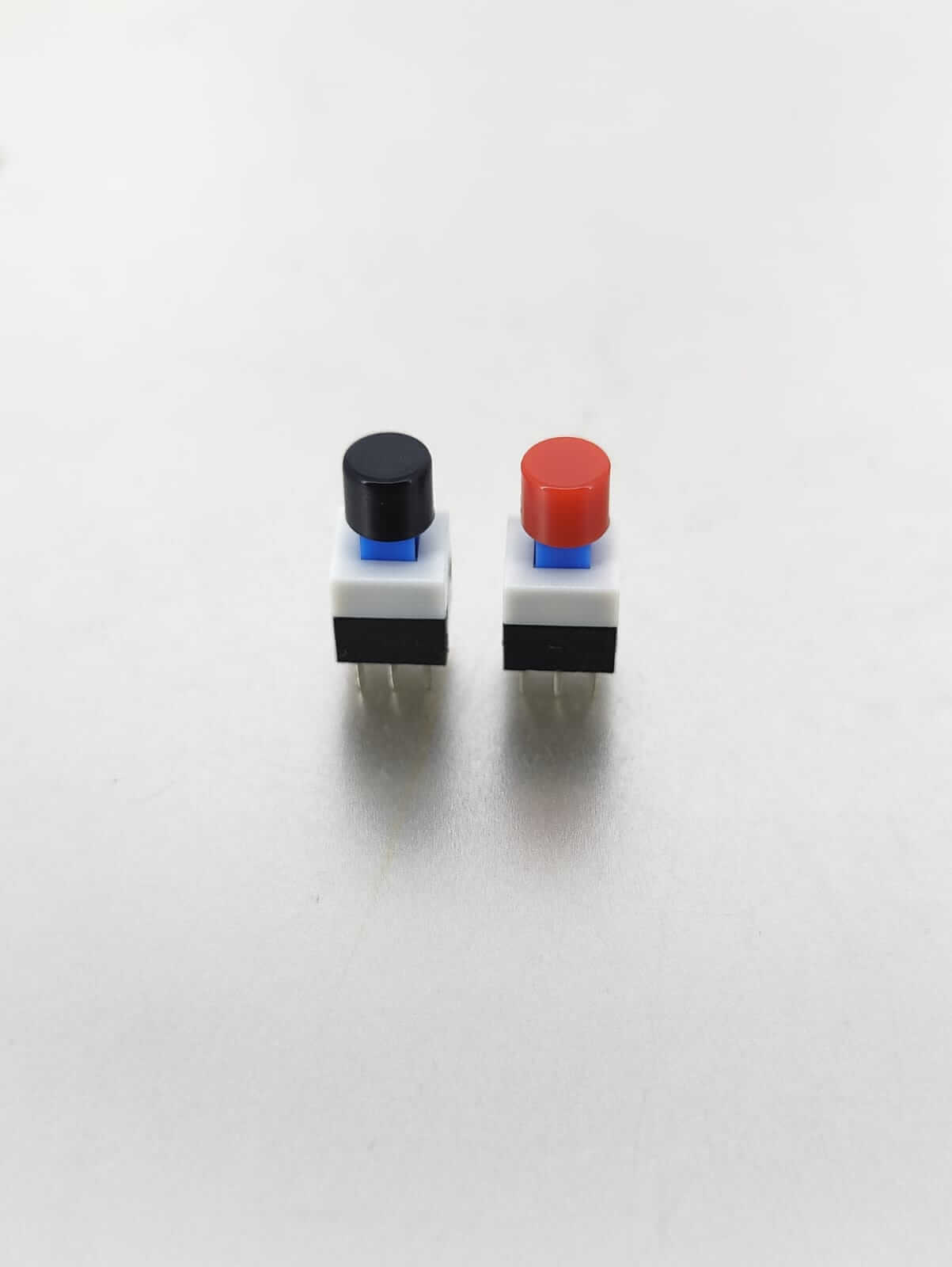 Two tactile mini push button switches in black and red, 8x8mm size, with 6-pin configuration for electrical applications.