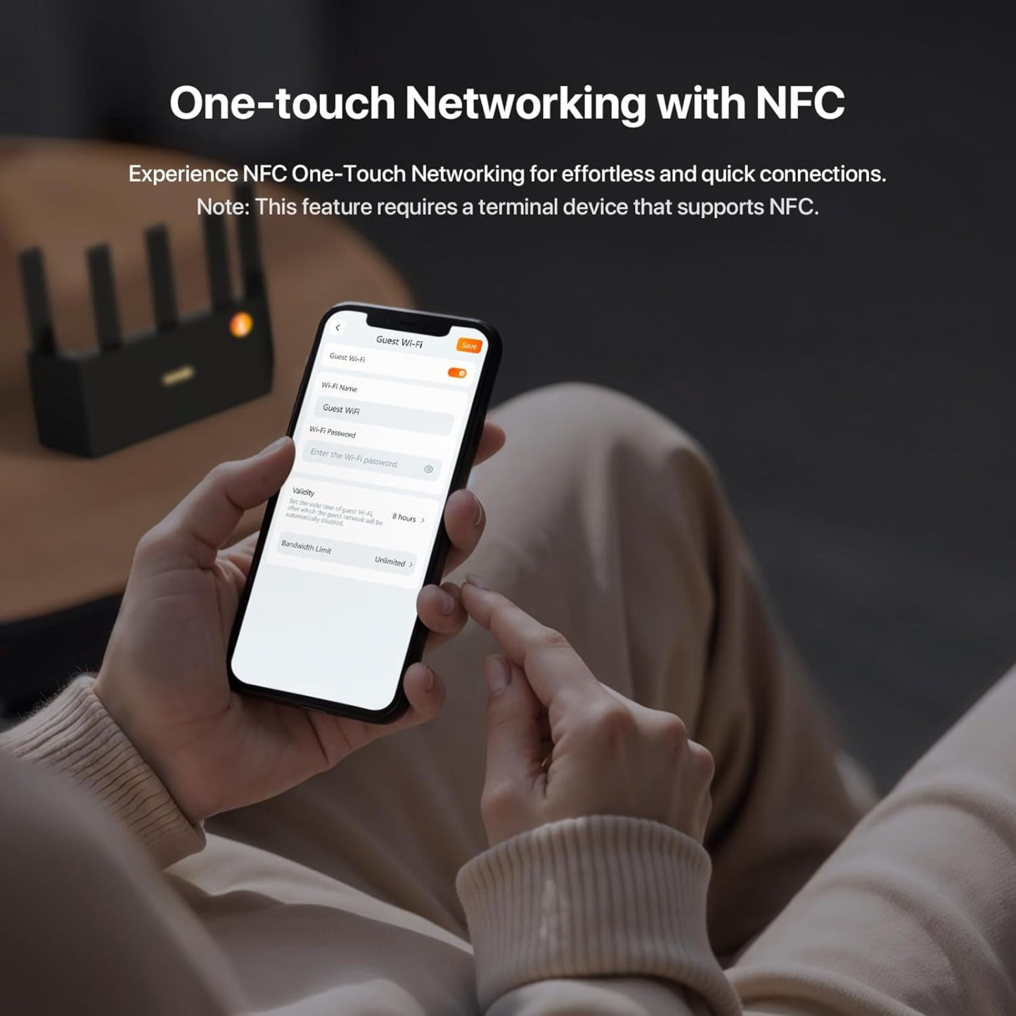 A user demonstrating the one-touch NFC networking by tapping a smartphone on the Tenda BE5100 router.