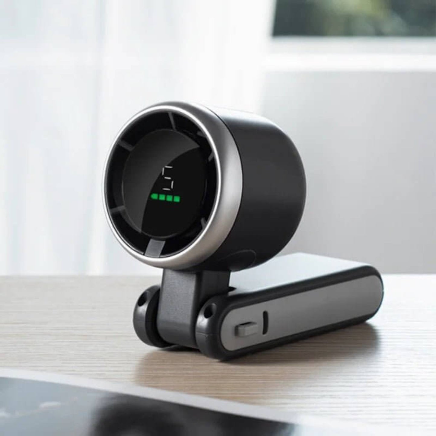 Black turbo fan folded into desk mode, clearly showing the 5-speed setting and battery life on the LED display.