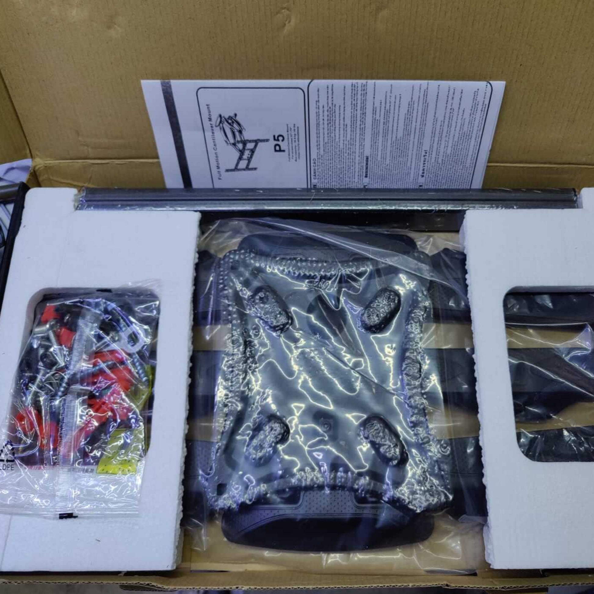 Full Motion TV Wall Mount P5 unboxed, including brackets and accessories, ready for installation.