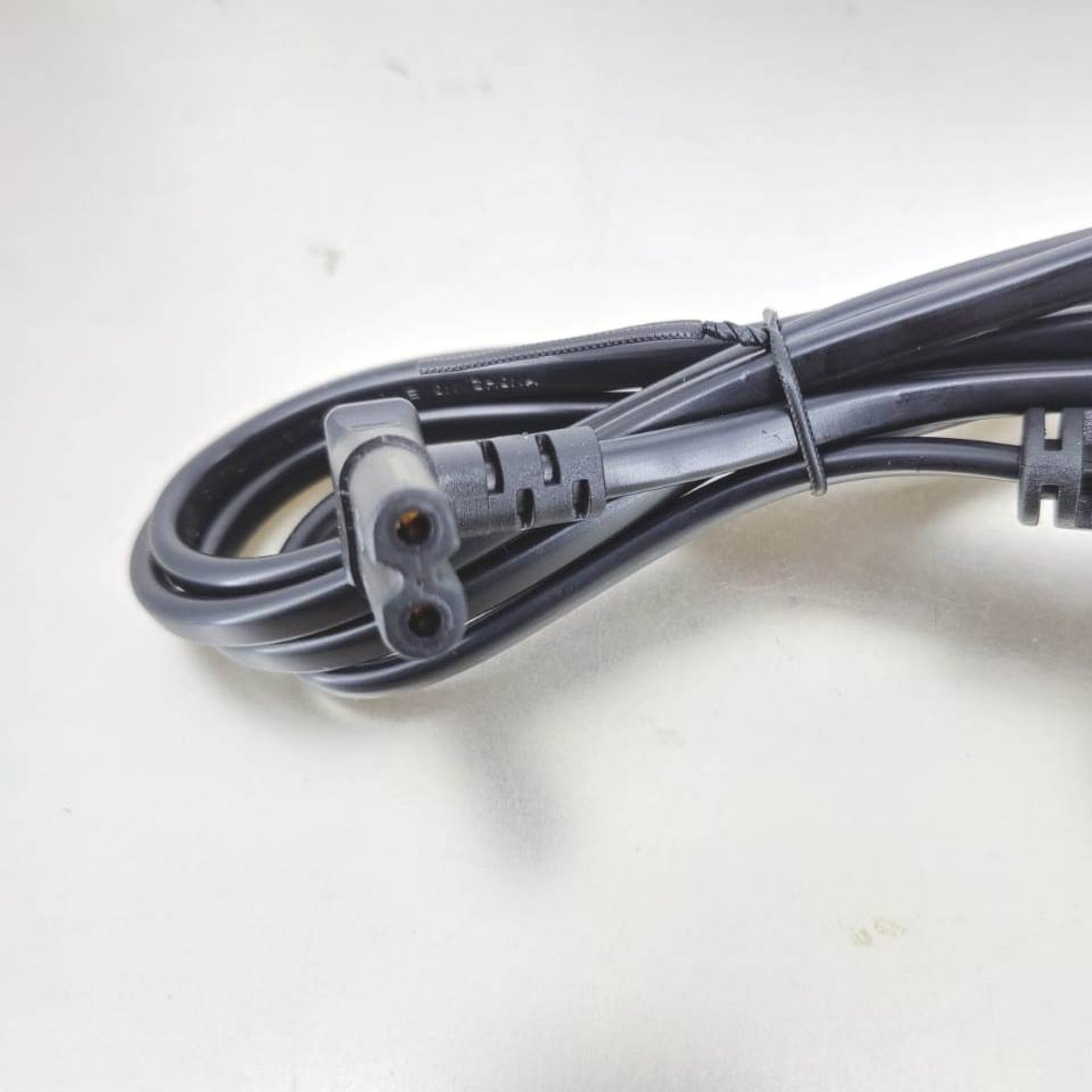 UK 3-pin to IEC C7 Figure 8 right angle power cable 1.5M for universal device compatibility.