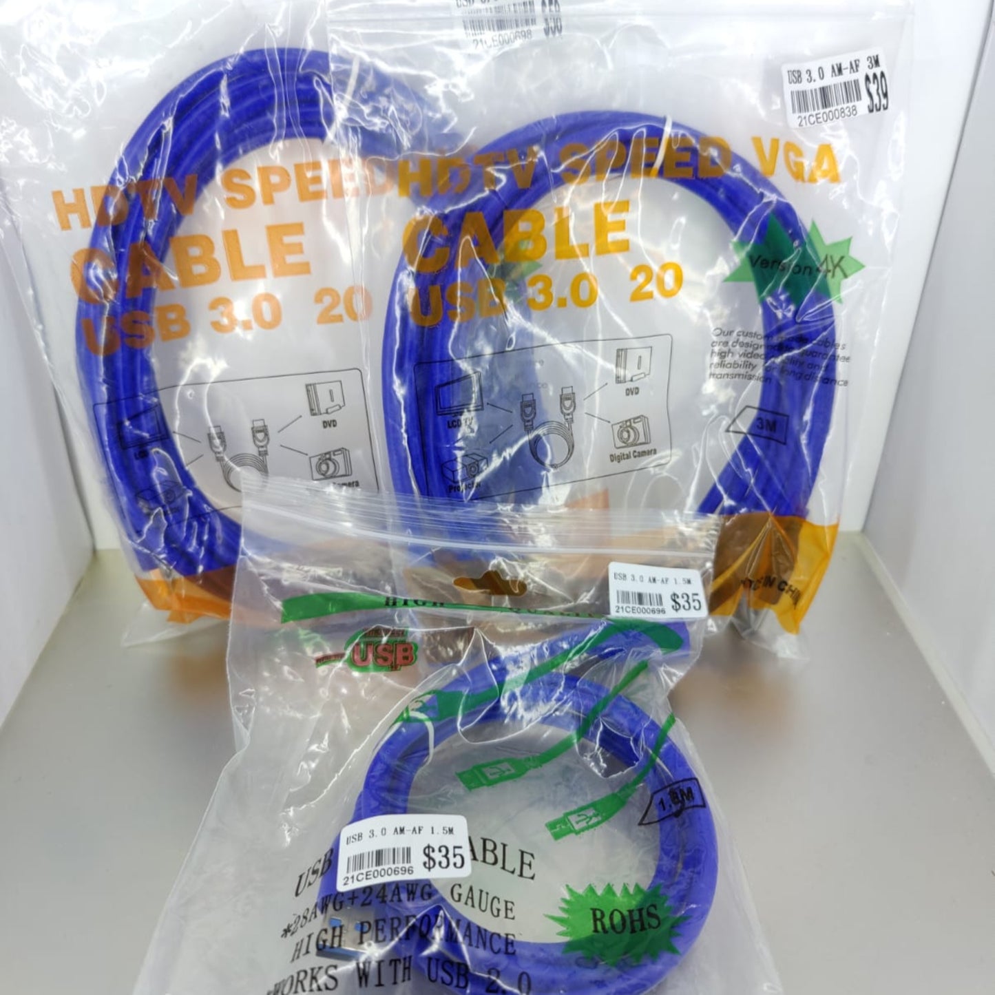 Three packages of high-speed USB 3.0 and VGA cables in blue, showcasing various lengths and price tags.