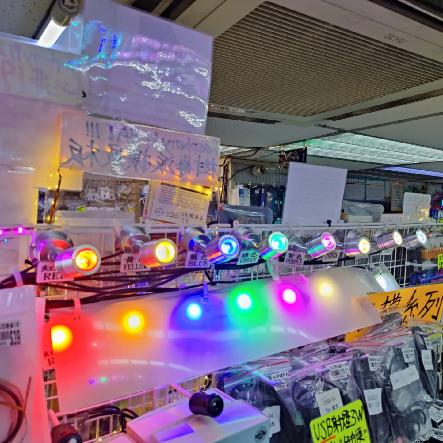 Colorful LED spotlights displayed in a shop, showcasing various lighting options for decoration and illumination.