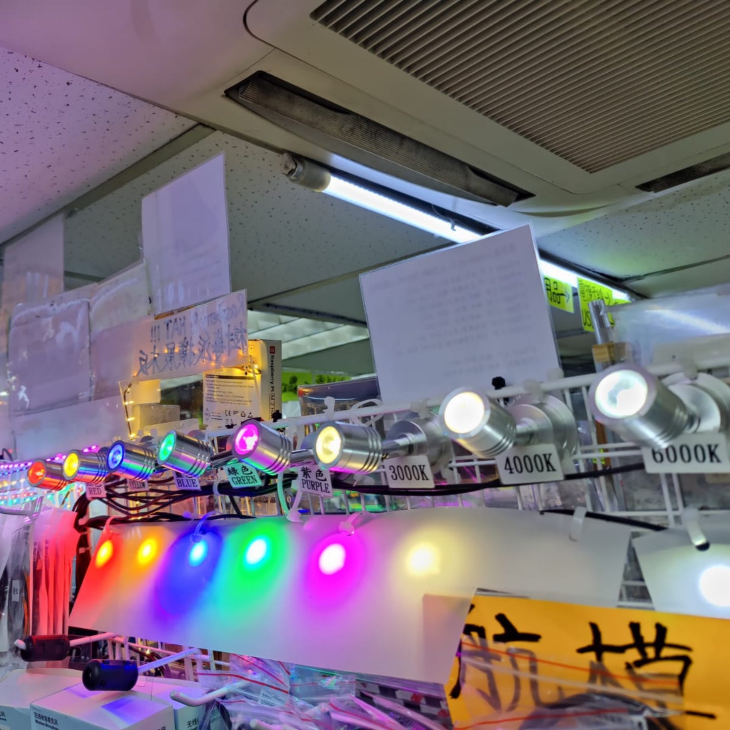 Display of various LED lights and accessories in a retail setting with colorful illumination.