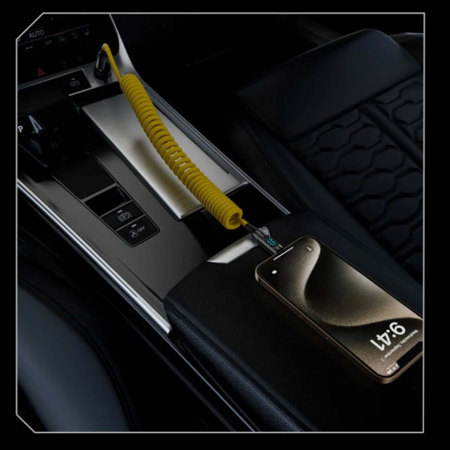 Yellow coiled USB-C cable charging a phone in a car, showing digital power display for fast charging.