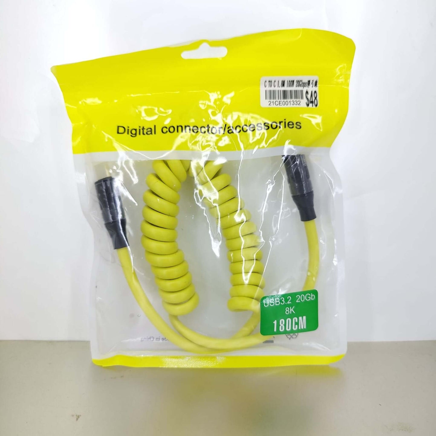 Packaged yellow coiled USB-C 100W cable with USB3.2, 20Gbps, 8K, 1.8m; digital connector accessory.