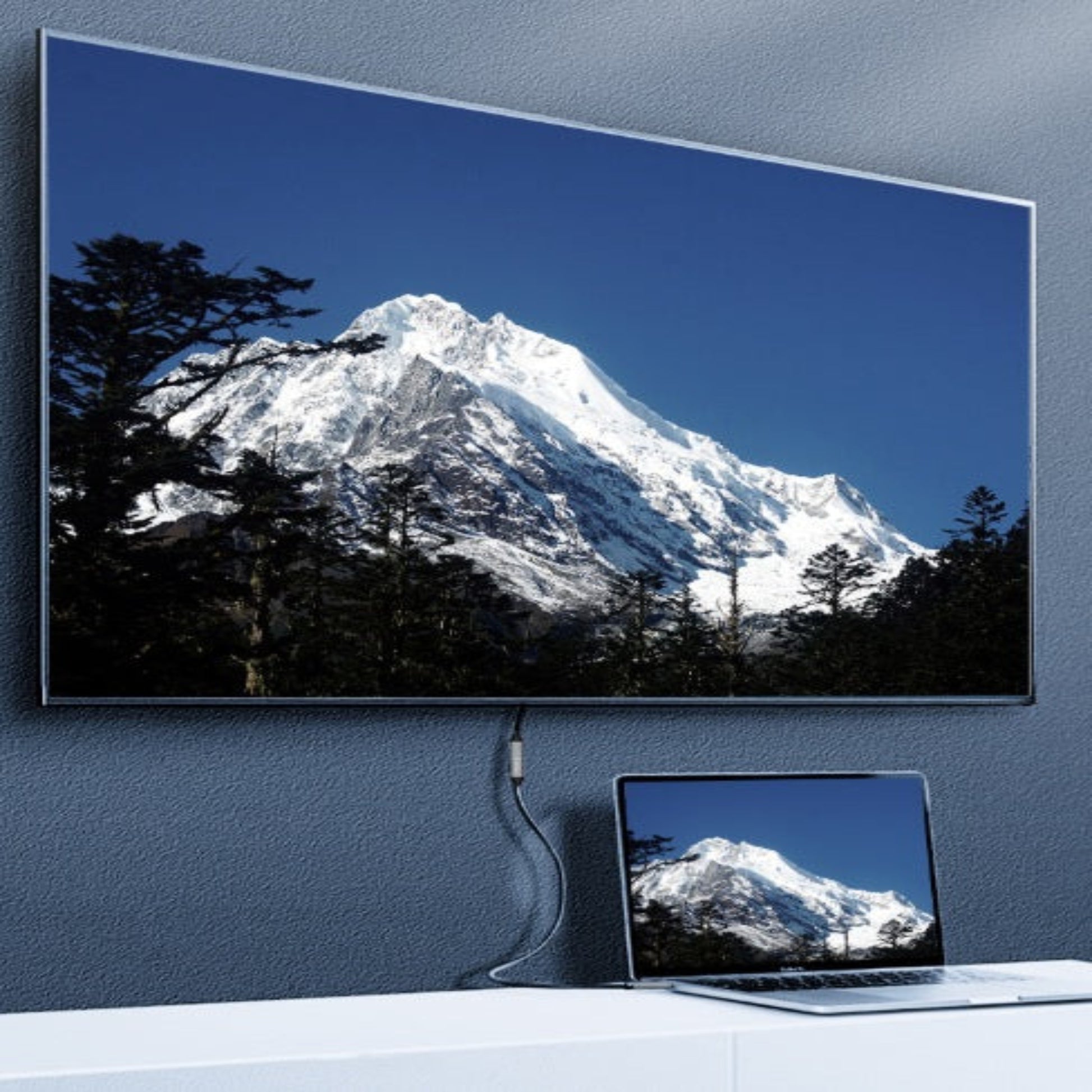 Laptop connected to a large external display using a USB-C extension cable, showcasing video transmission capability.