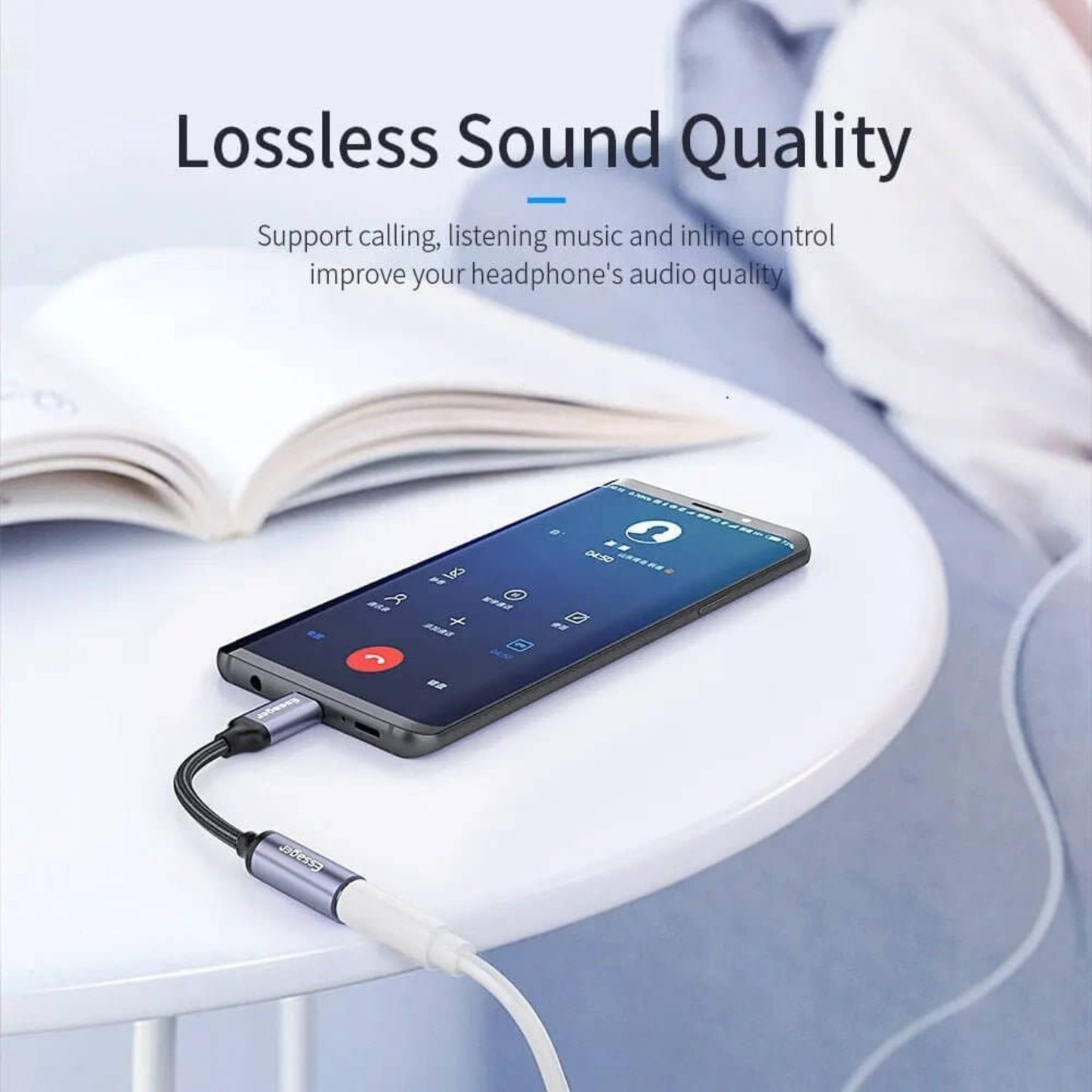 USB C to 3.5mm adapter connected to phone and white headphones for lossless sound quality.