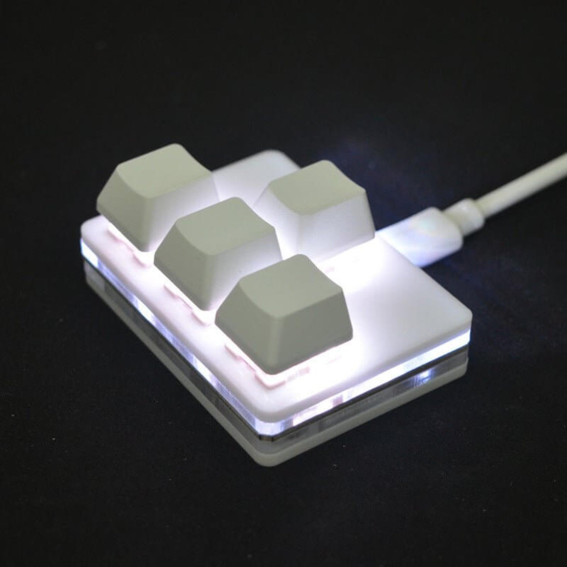 USB multifunctional mini keypad with backlit keys for multimedia control and macro functions.