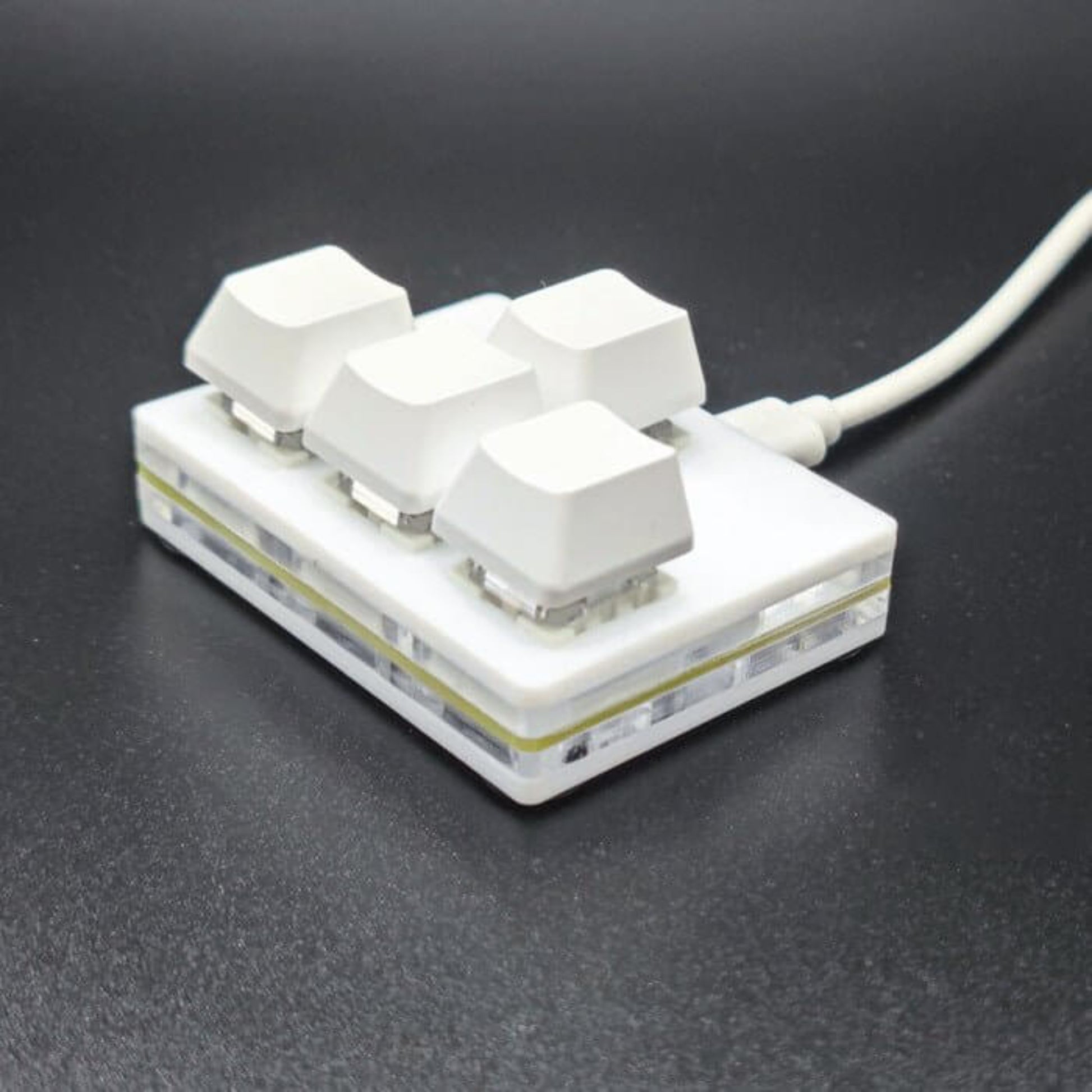 USB multifunctional mini keypad with four keys, designed for macros and multimedia control.