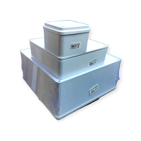 A stack of three different sized waterproof electrical junction boxes (3x3, 6x6, and 9x9 inches).