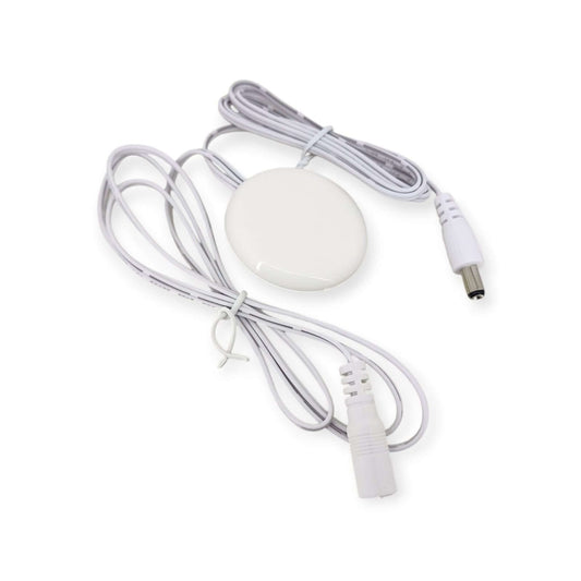 Top view of the white, round touchless wave sensor switch for LED lights, showing the DC input and output cables.