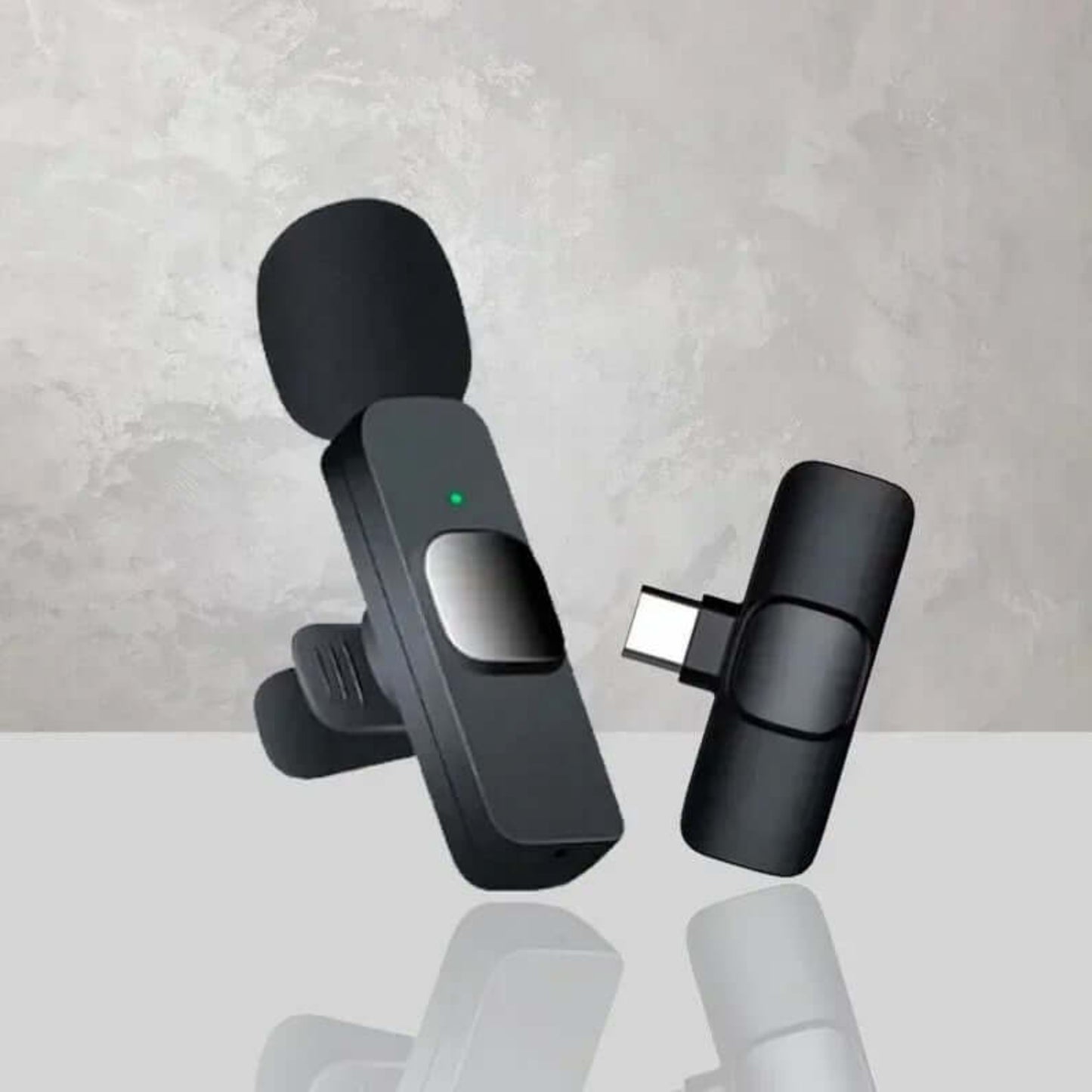 Close-up of wireless lavalier microphone transmitter and receiver units.