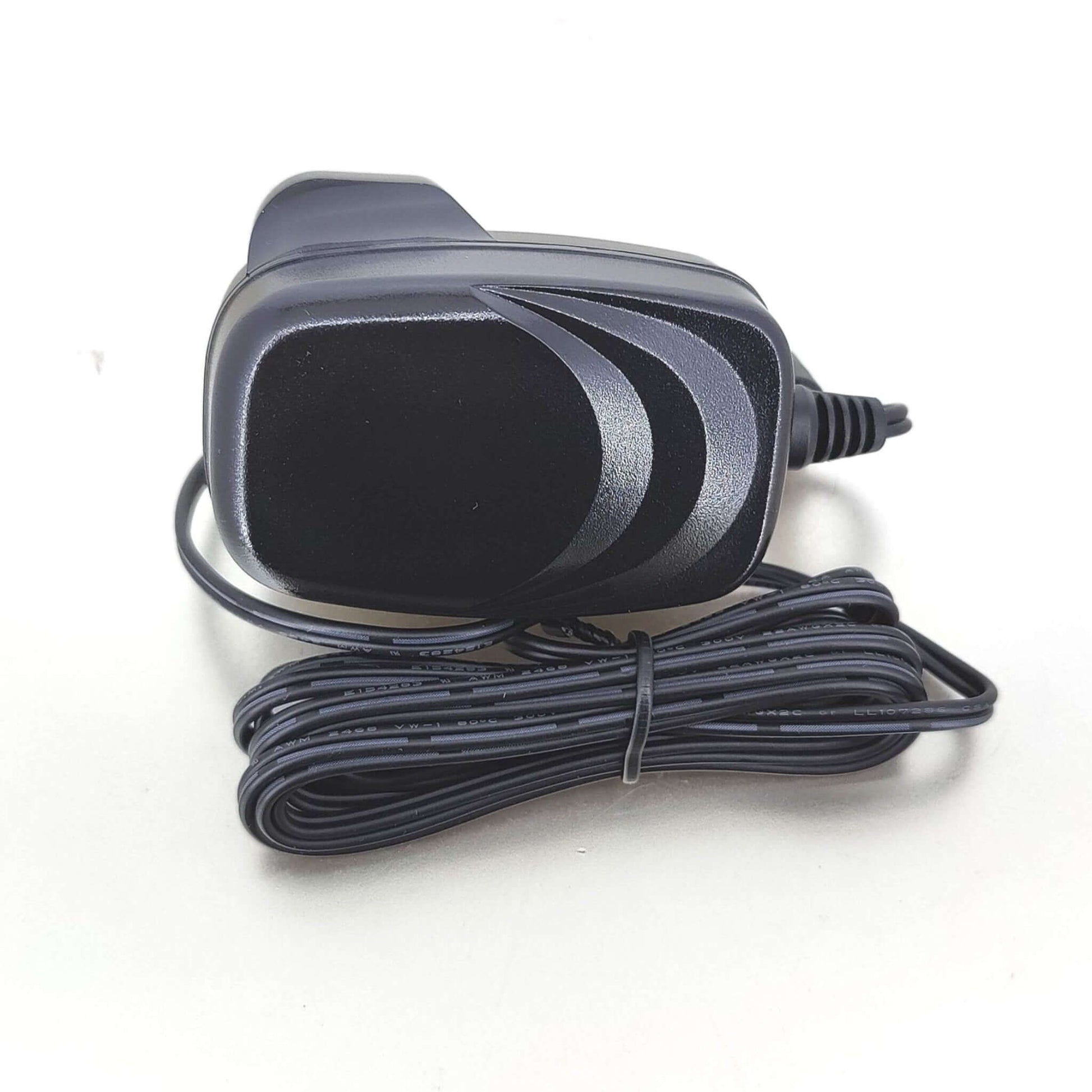 12V 1A DC power adapter with UK plug and attached cable on a light background.