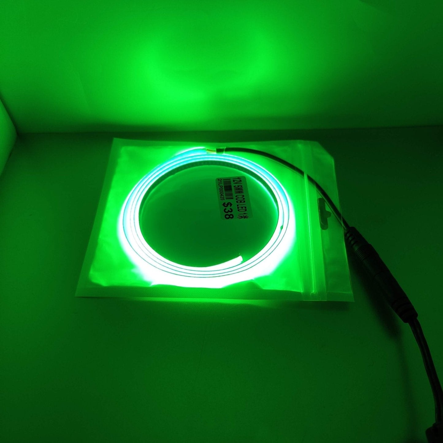 Green 12V 5mm LED light strip in packaging, ideal for room and car decoration.