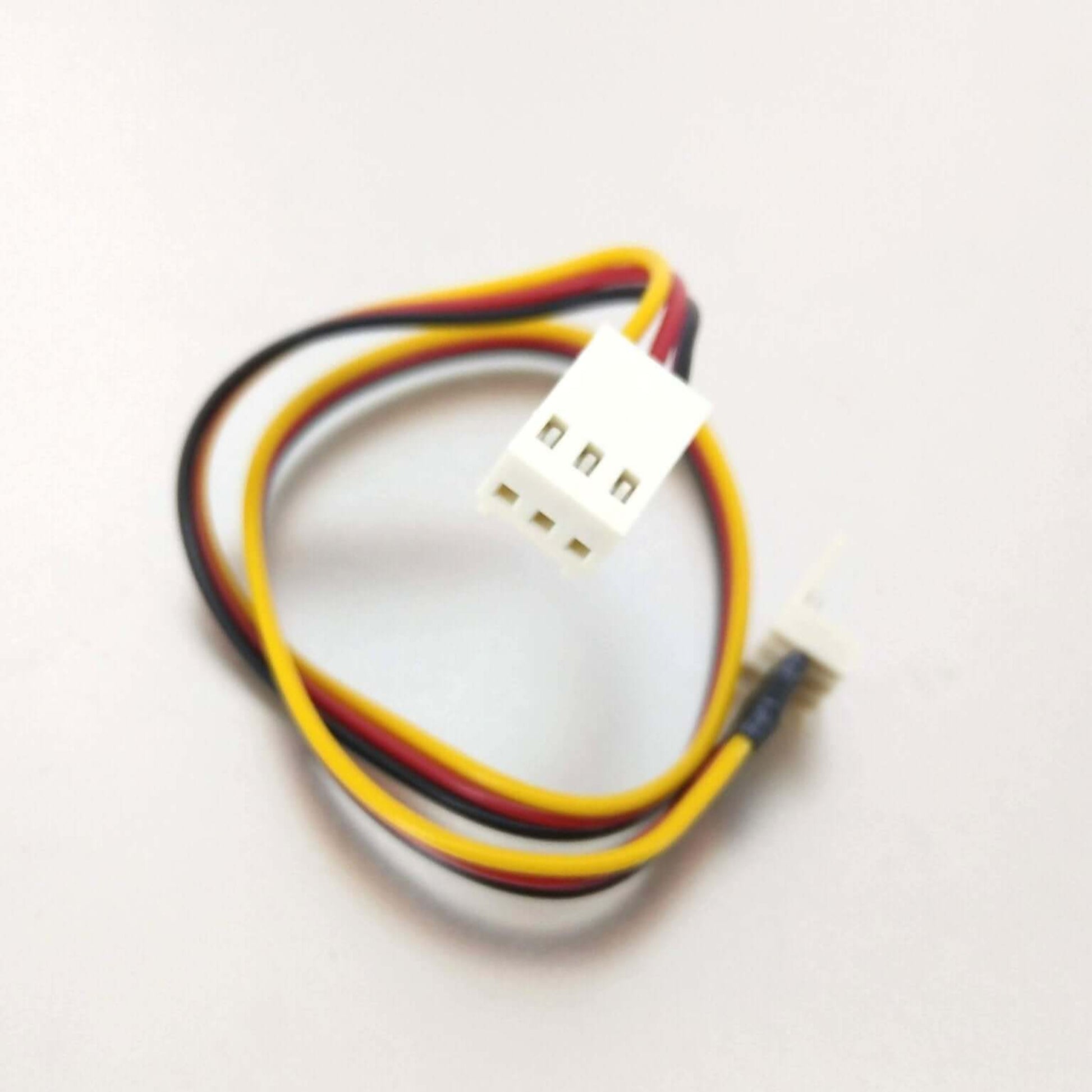Close-up shot of the white 3-pin female connector on the fan extension cable.
