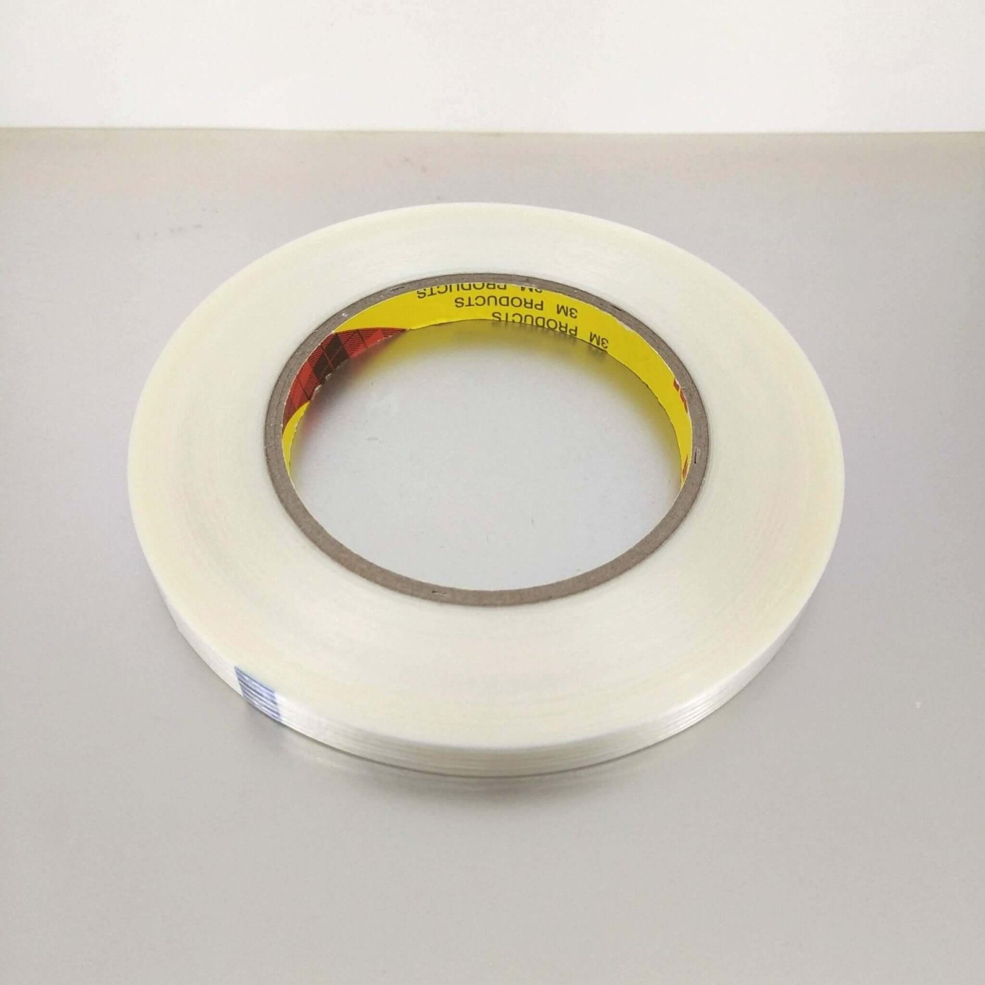 3M 8915 High Strength Fiberglass Filament Tape on a white background, showcasing its clear and durable design.
