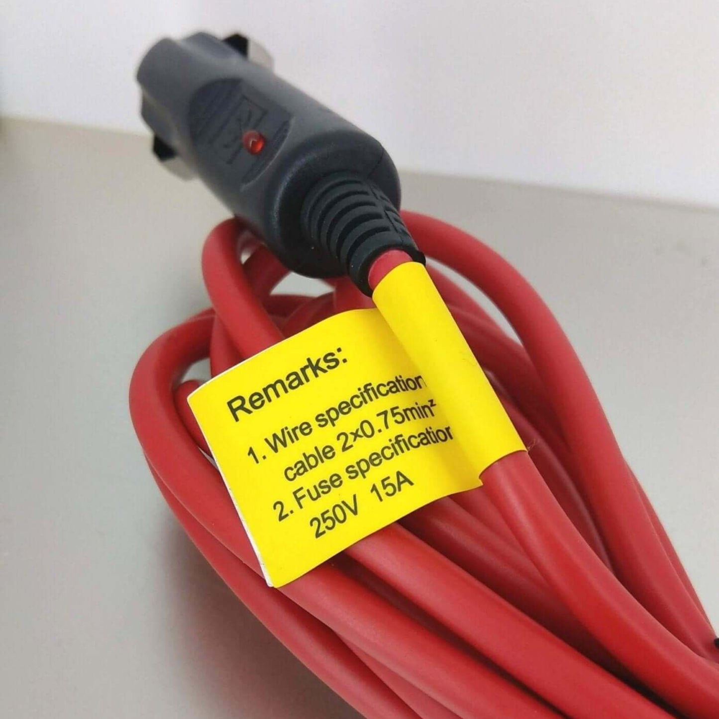Close-up of a 3m heavy duty car cigarette lighter extension cord with a yellow specifications label.