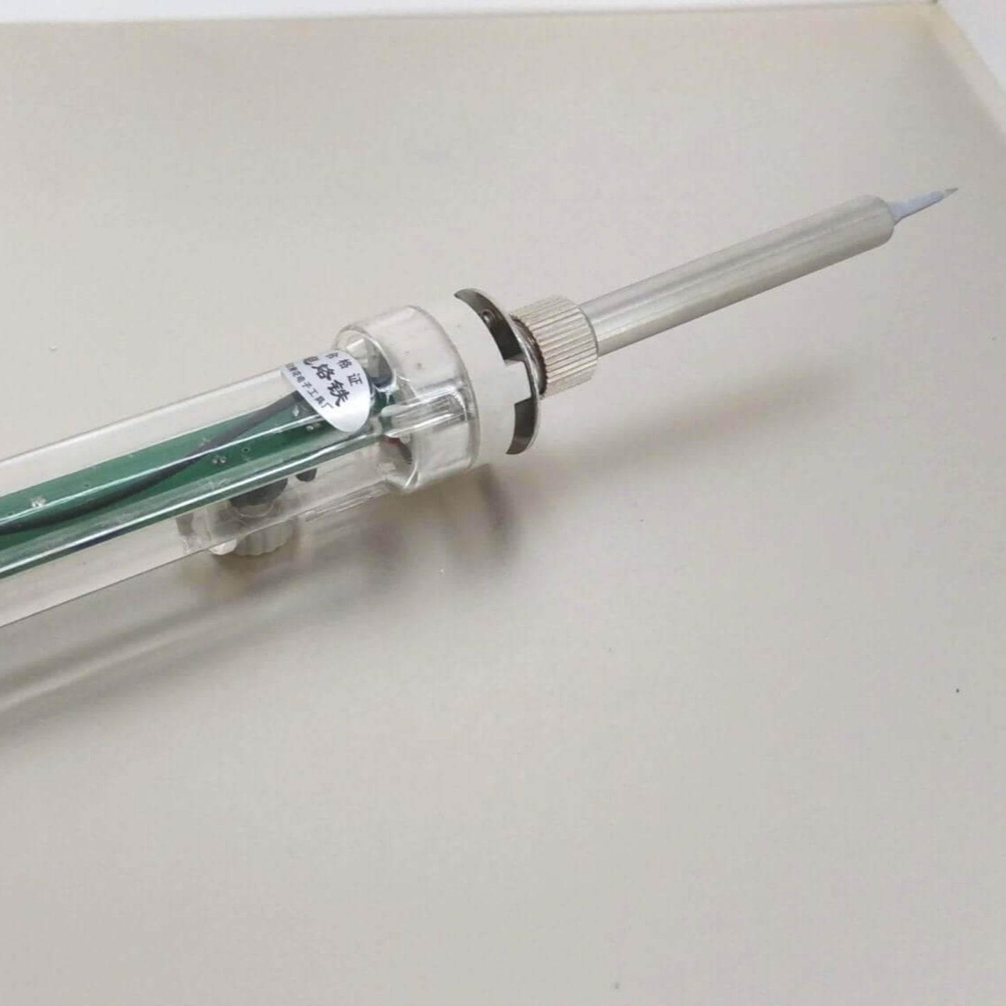 60W adjustable temperature soldering iron with a transparent design and integrated handle for precise electronic repairs.