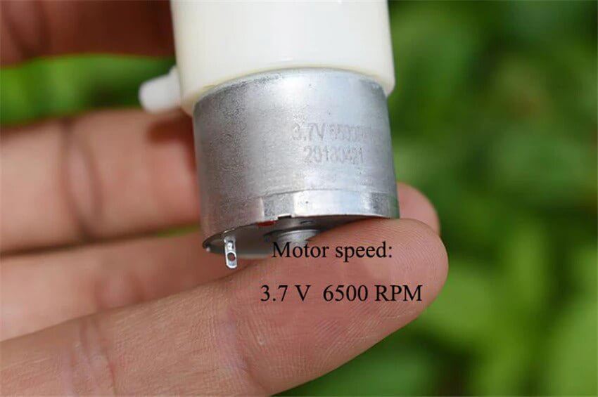 Close-up of a 310 mini vacuum pump motor showing specifications: 3.7V, 6500 RPM, ideal for negative pressure applications.