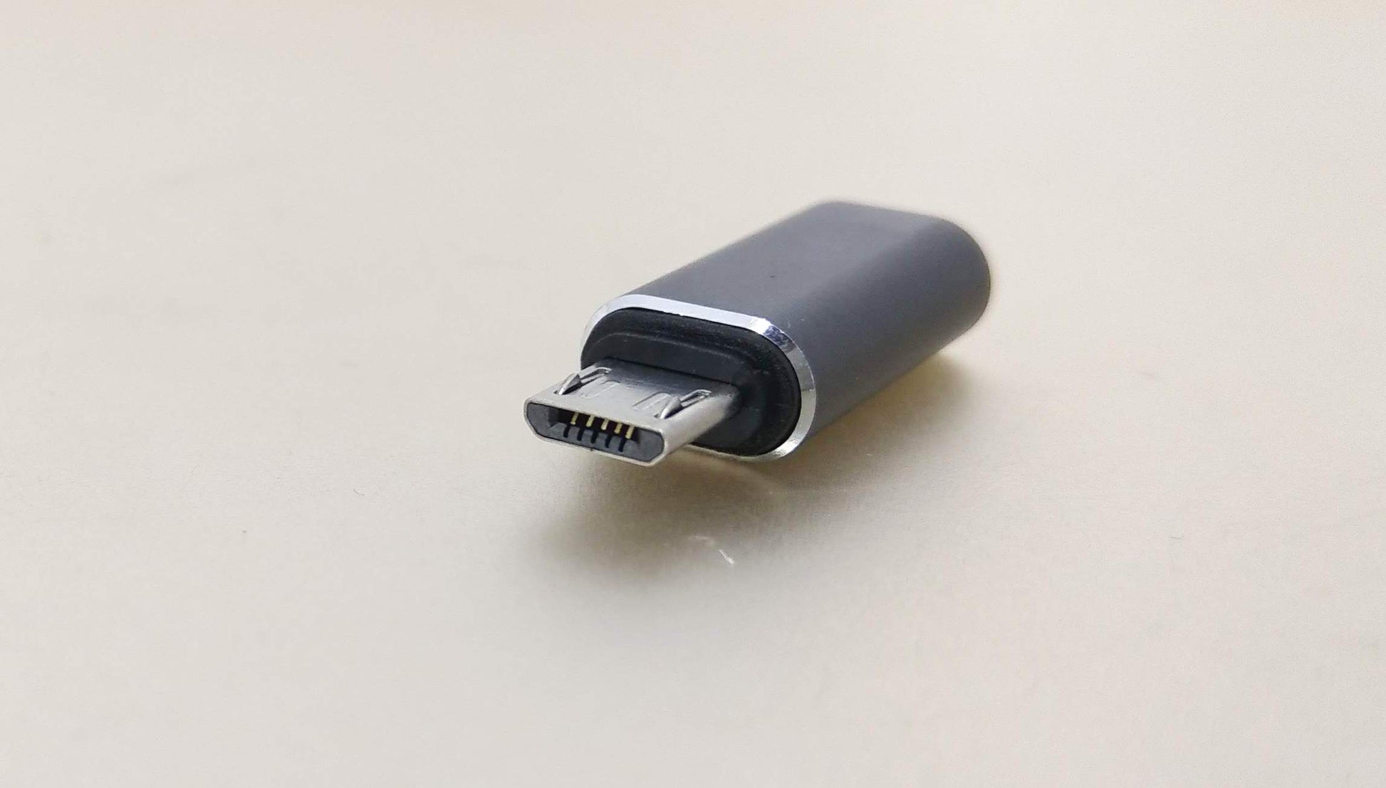 USB-C female to Micro USB male adapter for charging and data sync; compact and portable design.