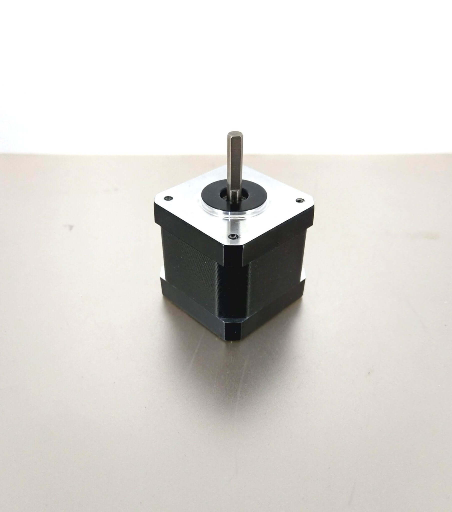 NEMA17 stepper motor with silver shaft on neutral background for CNC 3D printers and accessories.
