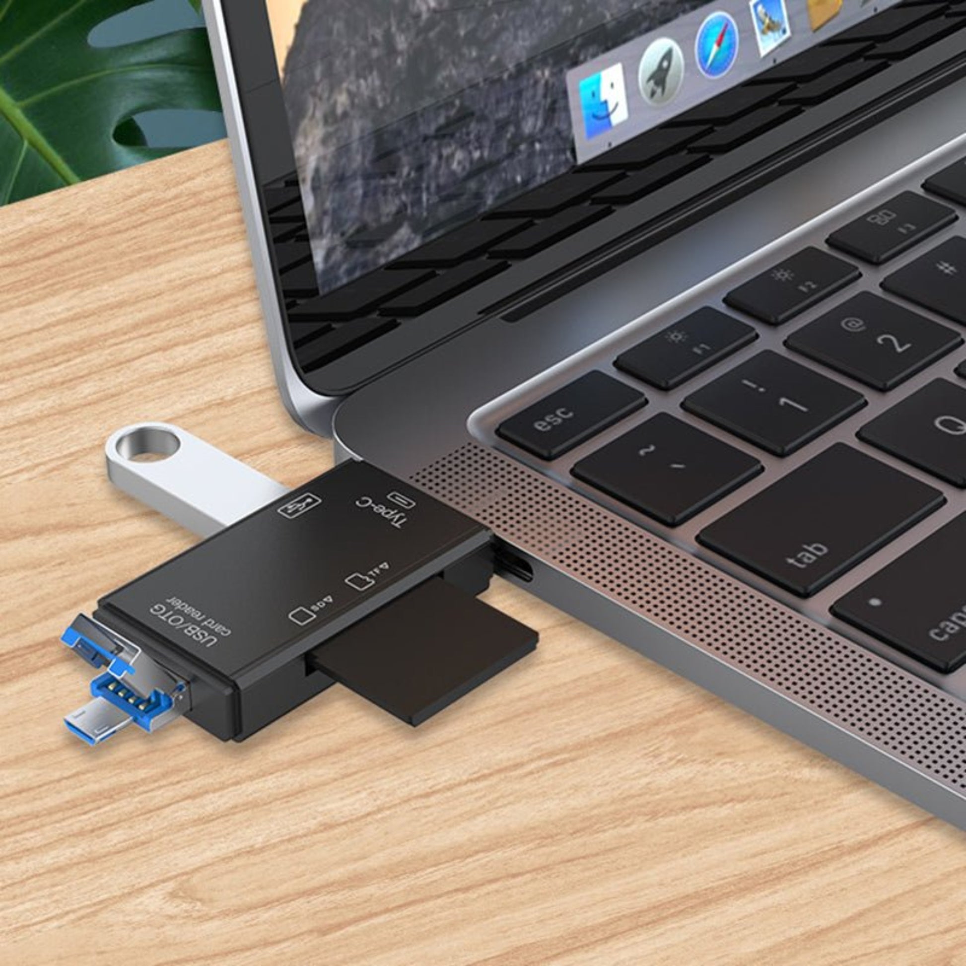 6-in-1 USB-C Micro USB SD/TF card reader connected to a laptop, showing versatile data transfer capability.