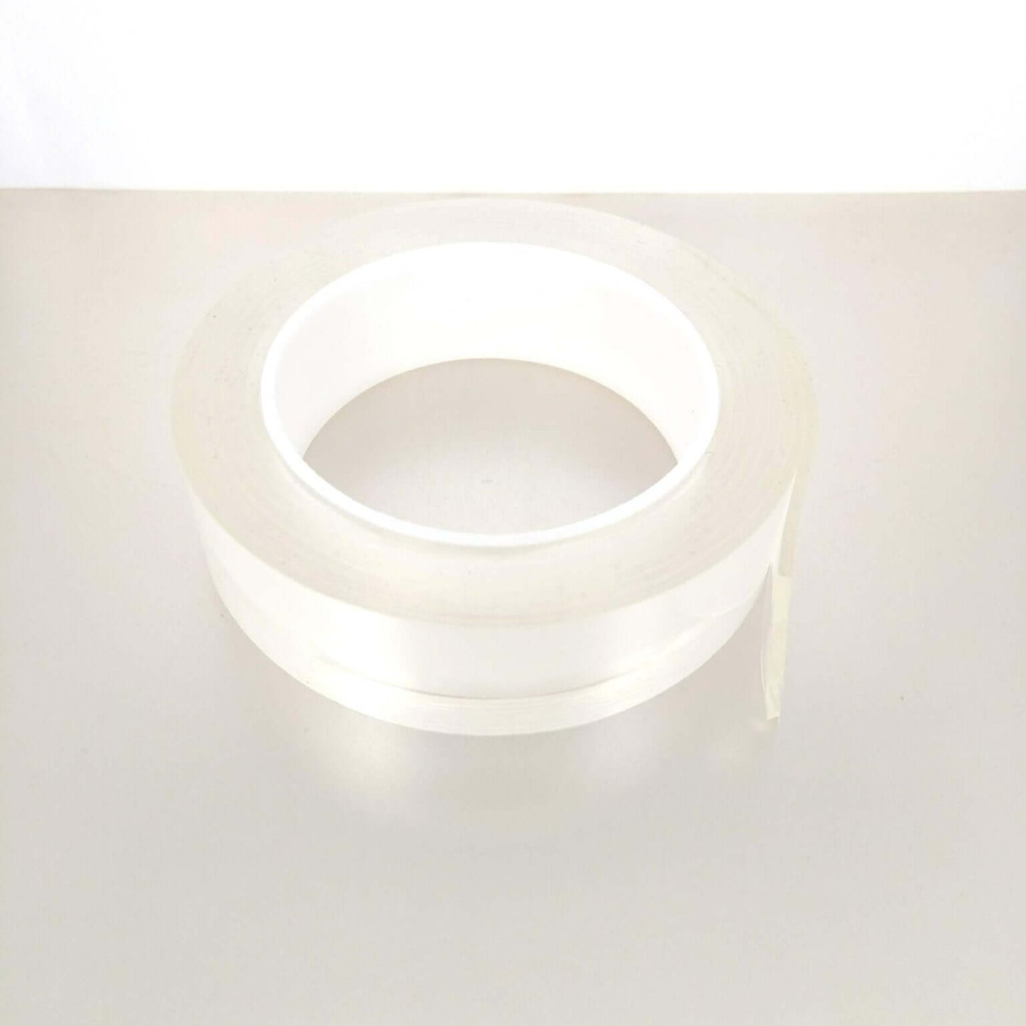 Roll of multi-functional nano adhesive tape by 3M, washable and reusable for easy organization.