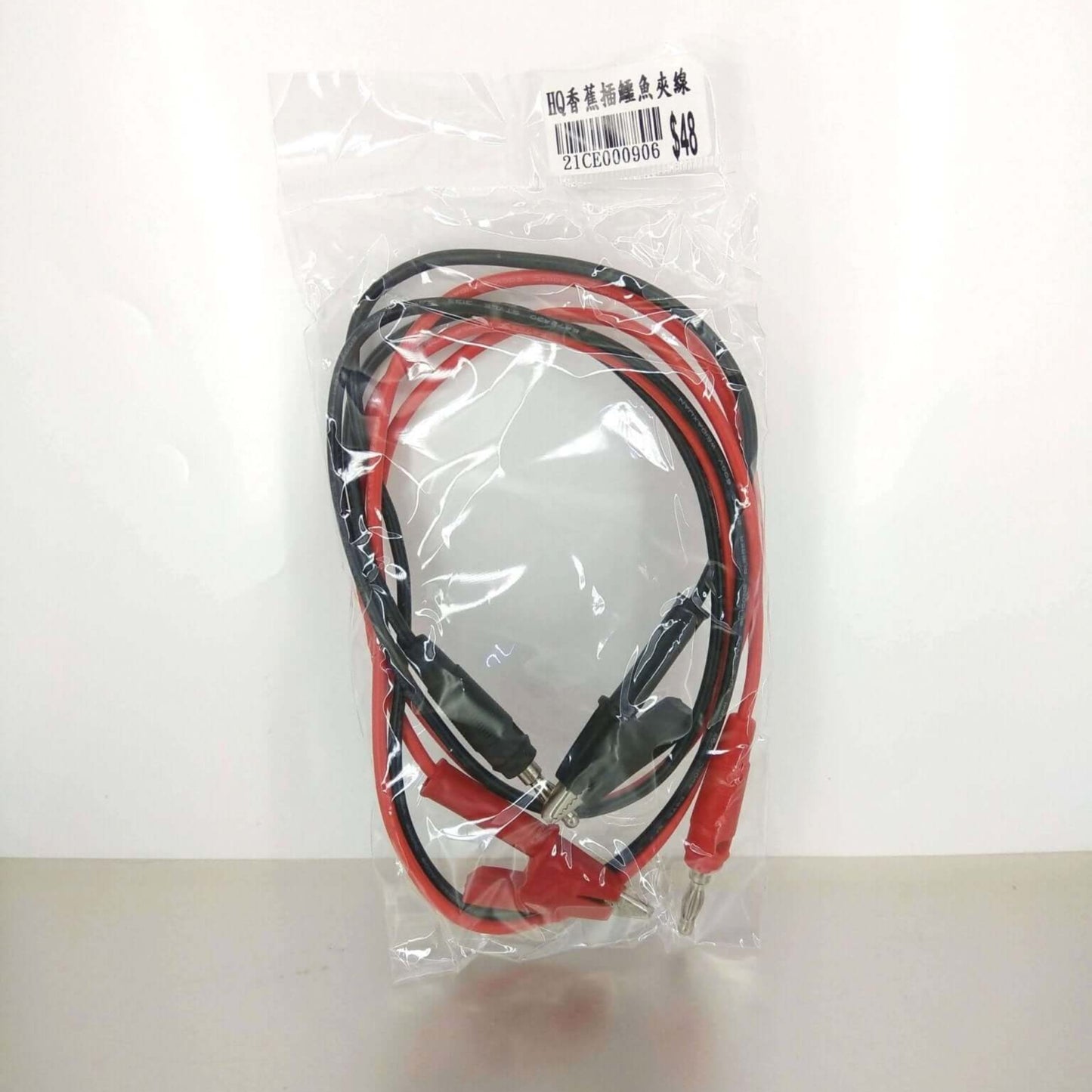 Packaged red and black alligator clip to banana plug test leads with price tag.