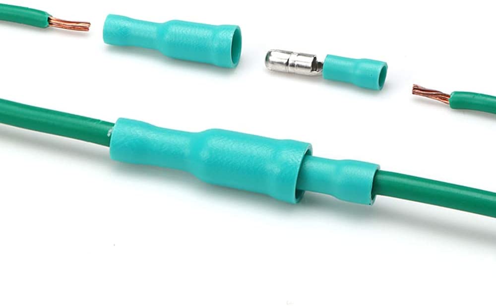 Close-up of insulated male/female bullet connectors for electrical wiring with green wires and crimp terminals.