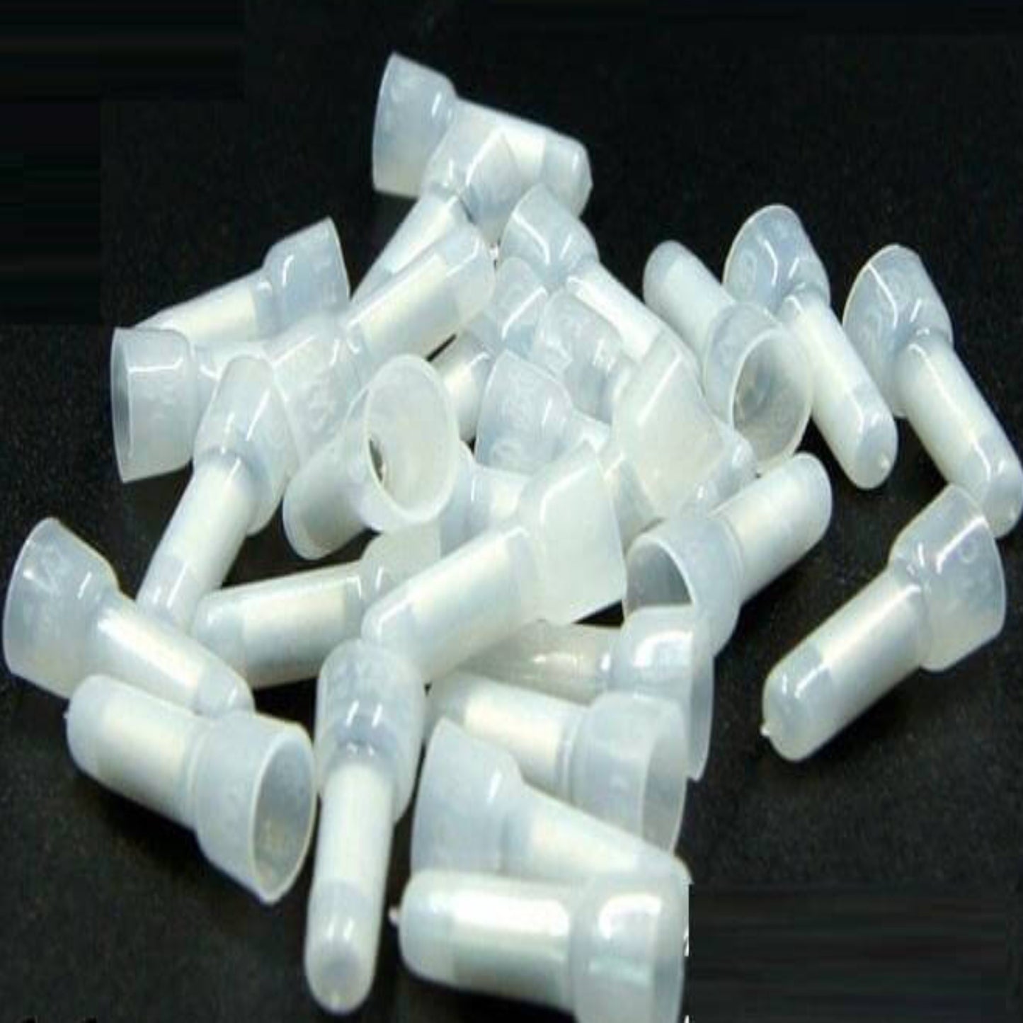A close-up view of multiple CE-2X closed-end wire connectors, showing the white PP material and internal aluminum tube.