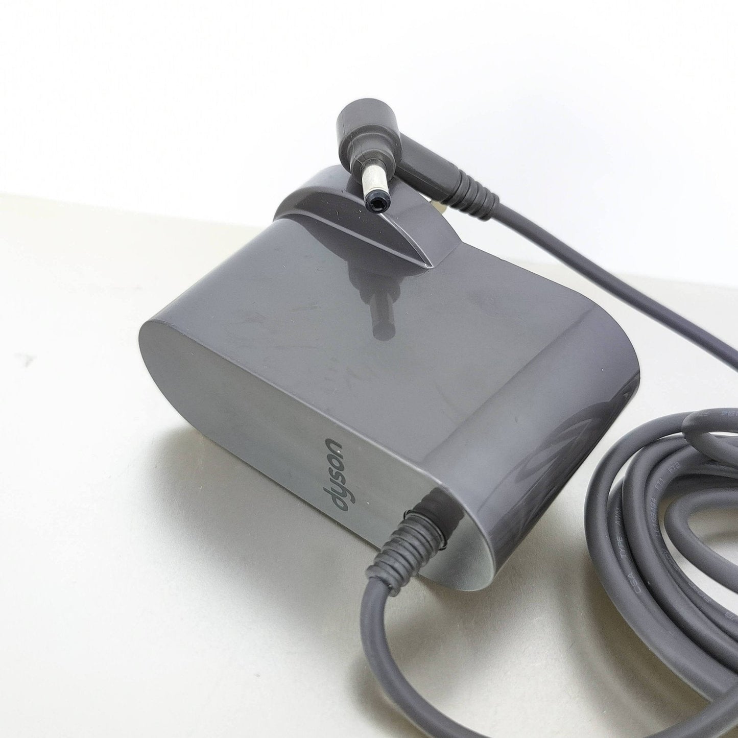Close-up of the output connector and grey power brick for the Dyson V10, V11, V12, V15 charger.