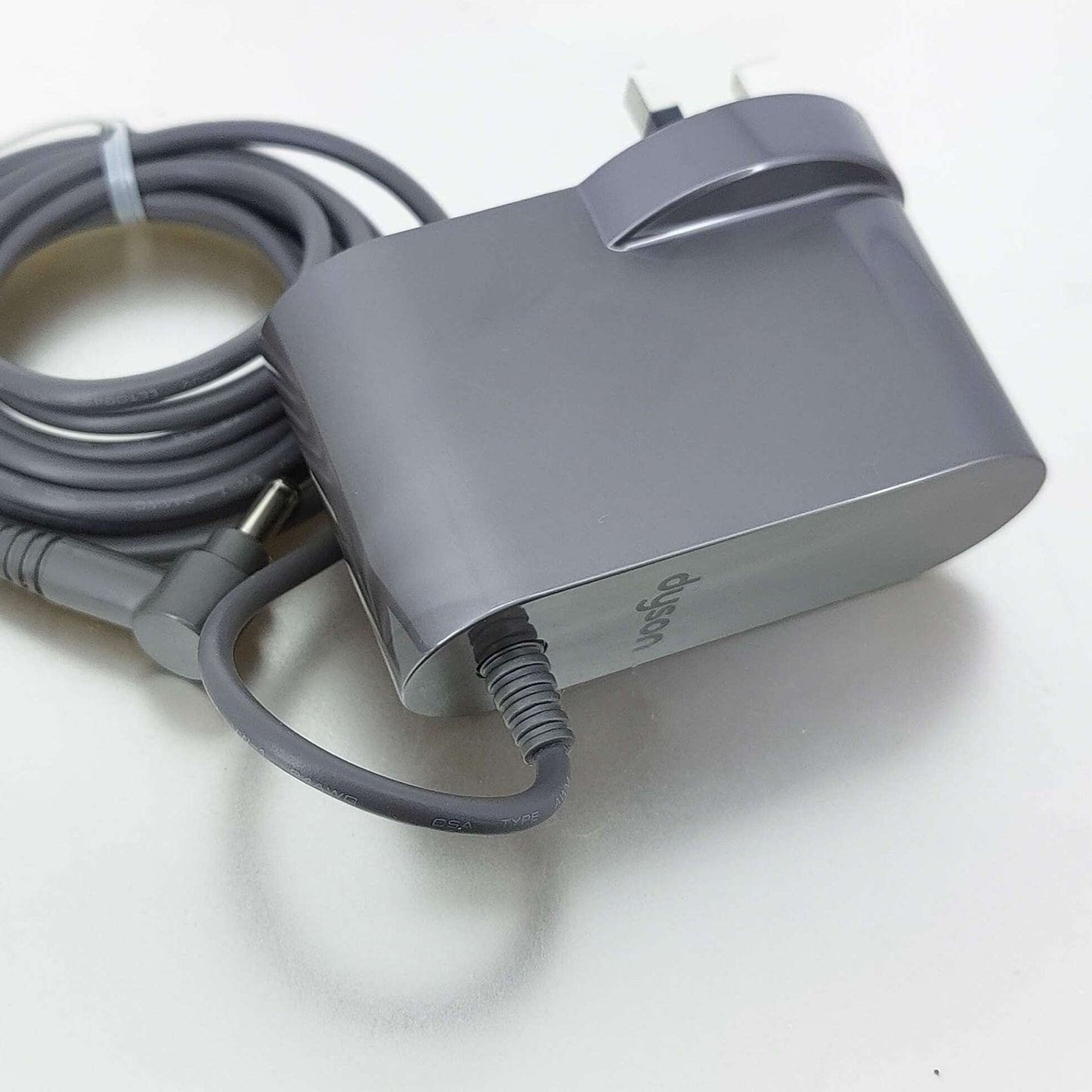 Grey UK plug charger for Dyson V10, V11, V12, and V15 vacuum cleaners.