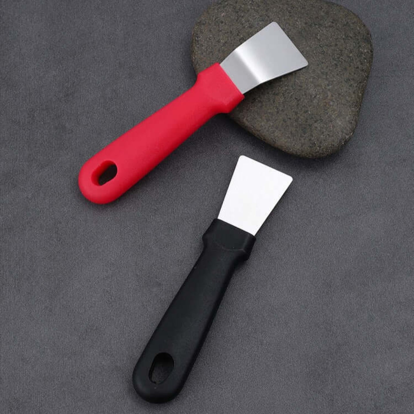 Stainless steel hand scraper set featuring red and black handles on a textured surface, ideal for kitchen and freezer use.