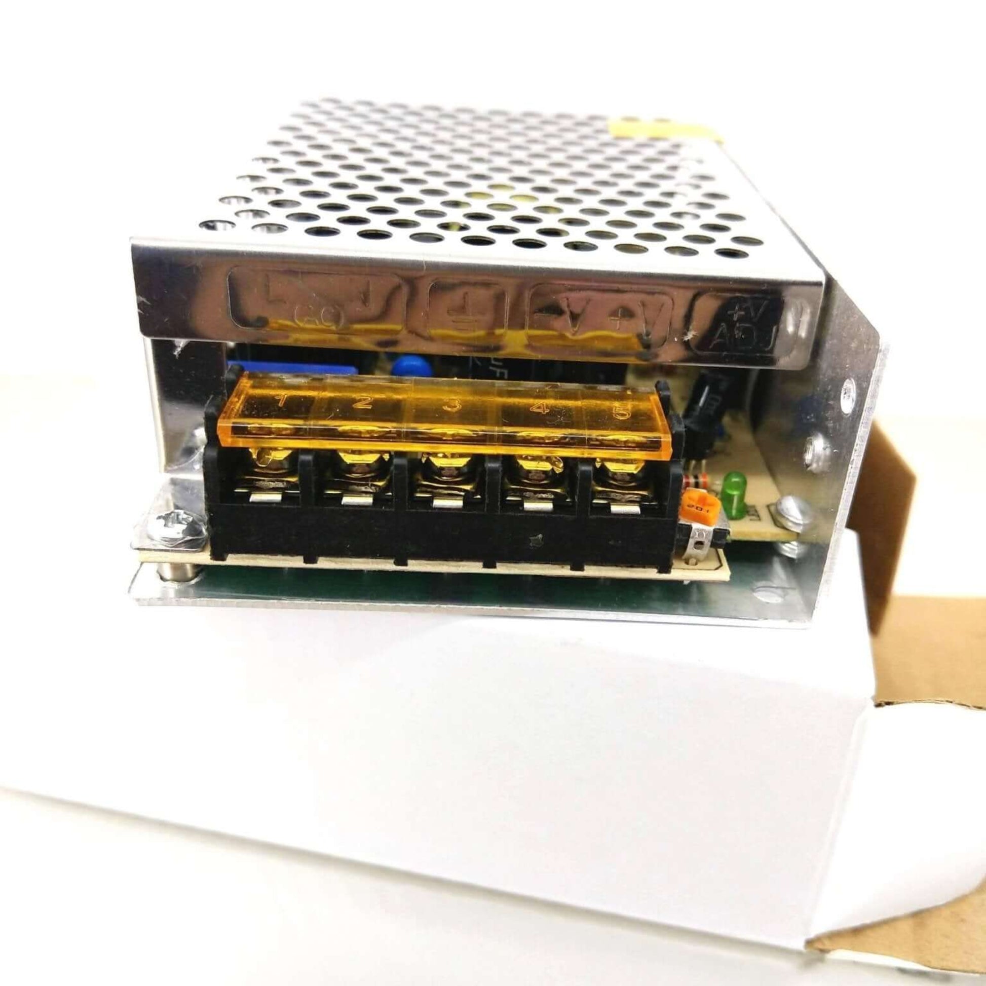 Close-up of the industrial grade DC switching power supply's robust perforated metal enclosure, ensuring efficient heat dissipation.