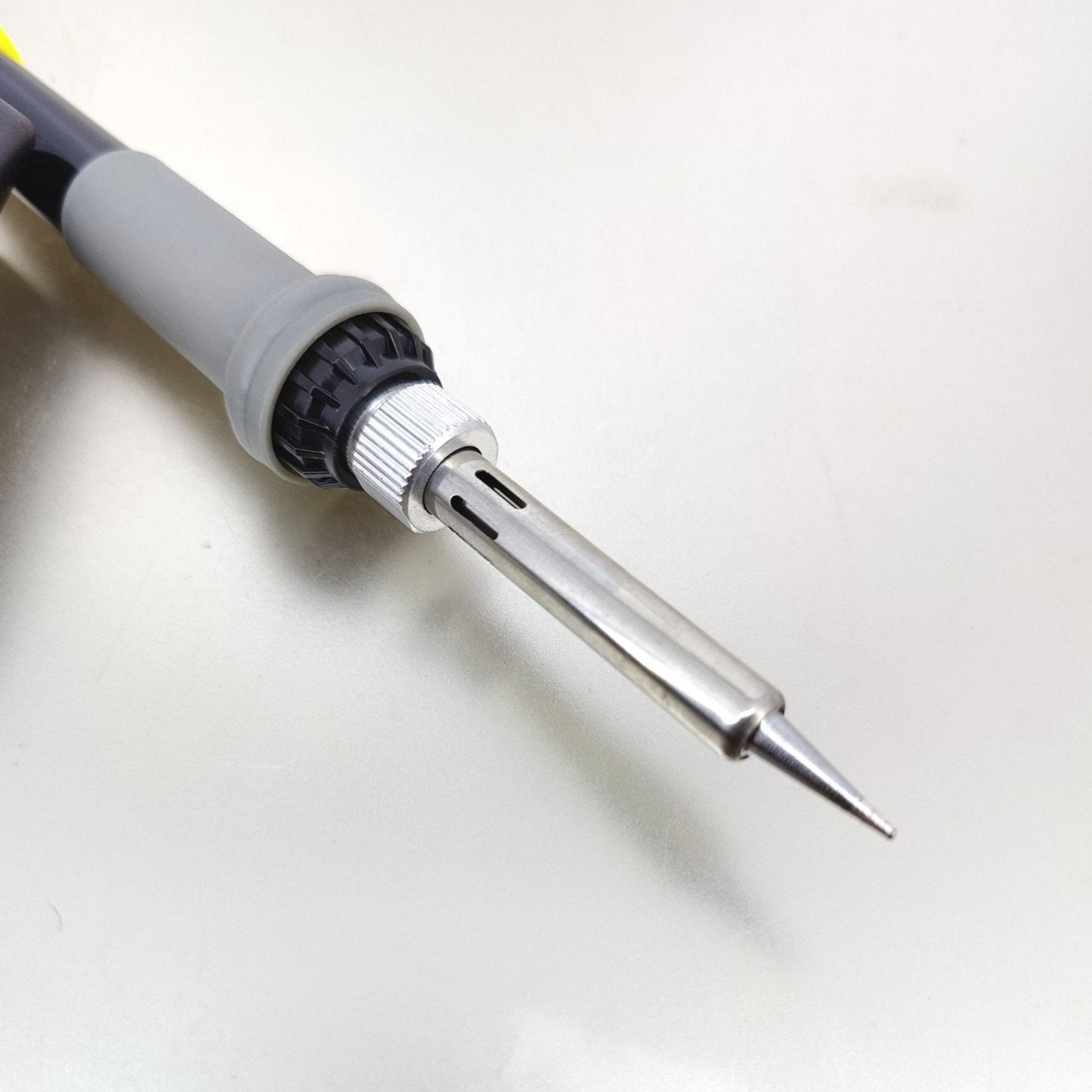 Close-up of adjustable temperature soldering iron tip, featuring stainless steel construction and heat-resistant design.