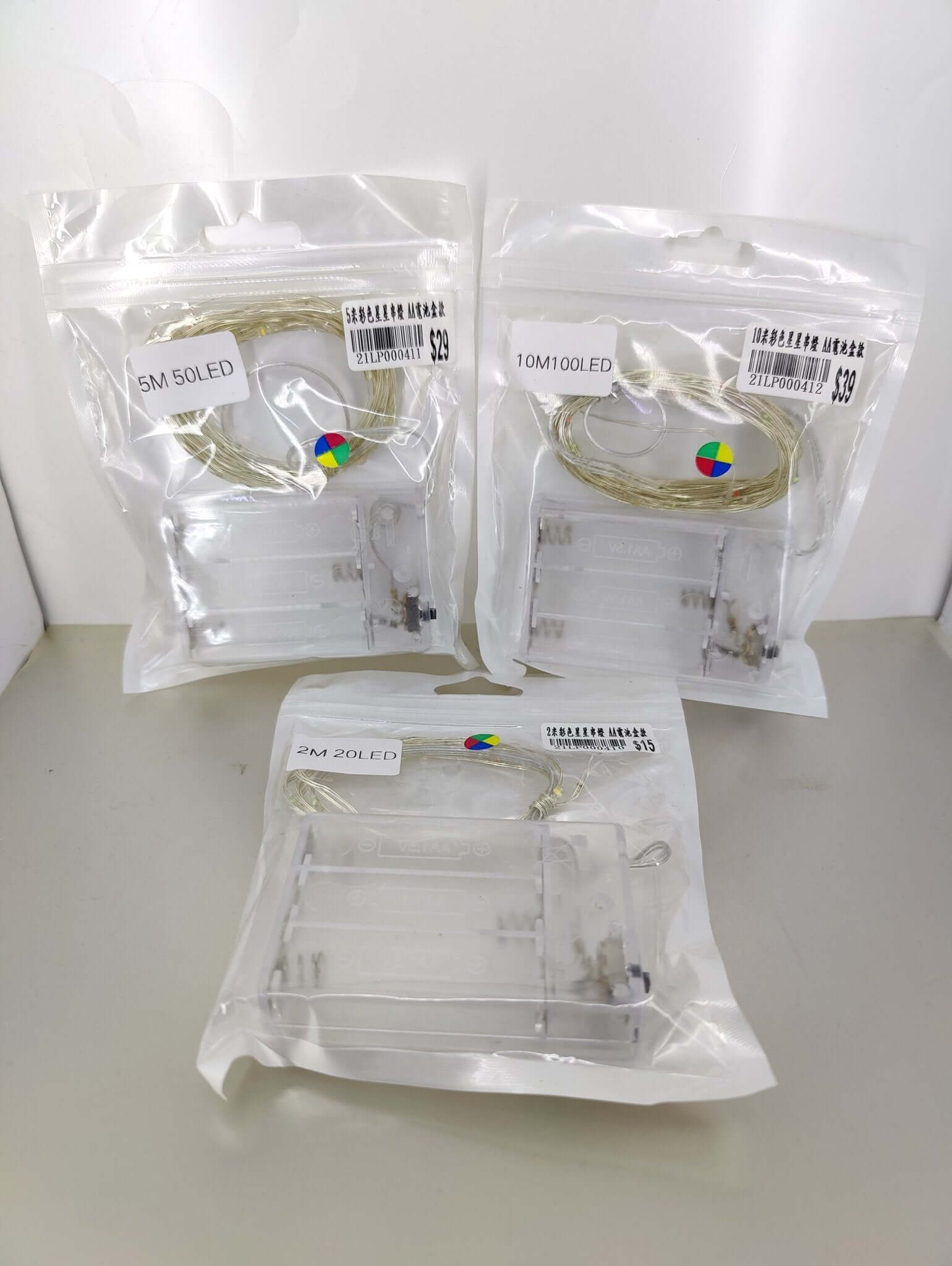 Multicolor LED fairy lights in packaging, battery-operated options 2M, 5M, and 10M for decorative use.
