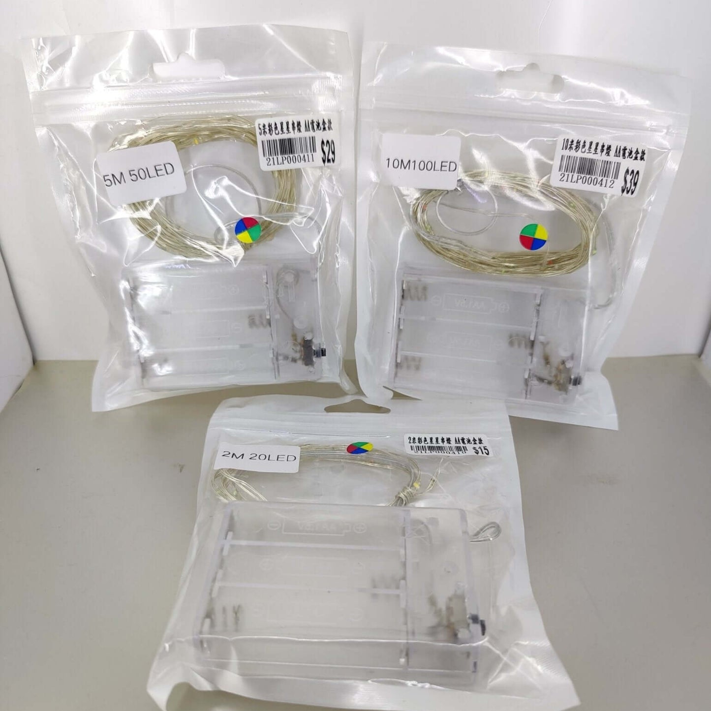 Multicolor LED fairy lights in packaging, battery-operated options 2M, 5M, and 10M for decorative use.
