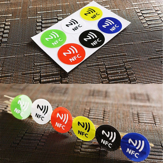 Colorful NTAG213 NFC sticker tags on a surface, showcasing versatility and waterproof design for smart automation.