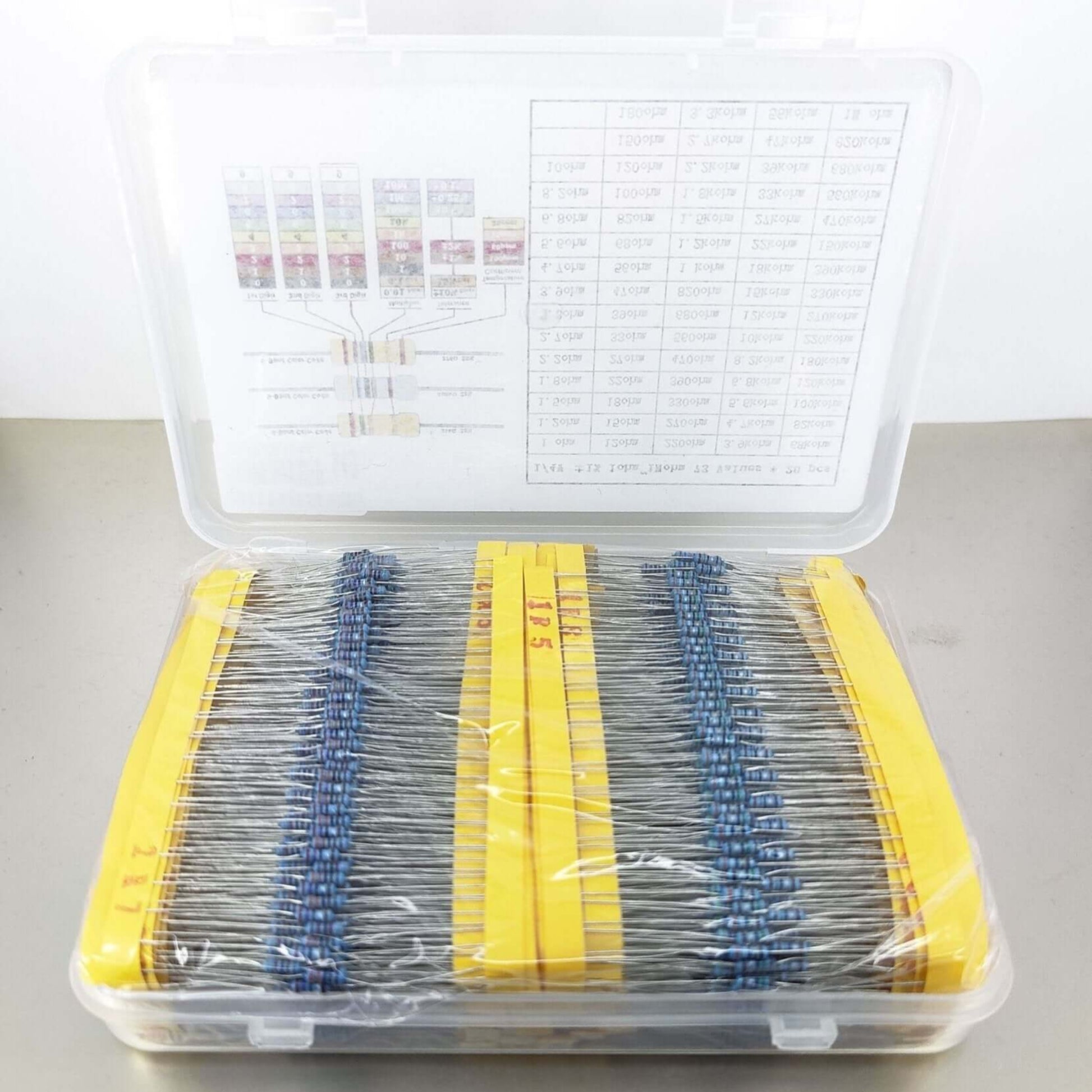 73 types metal film resistor kit in transparent case with yellow labels and organization chart.