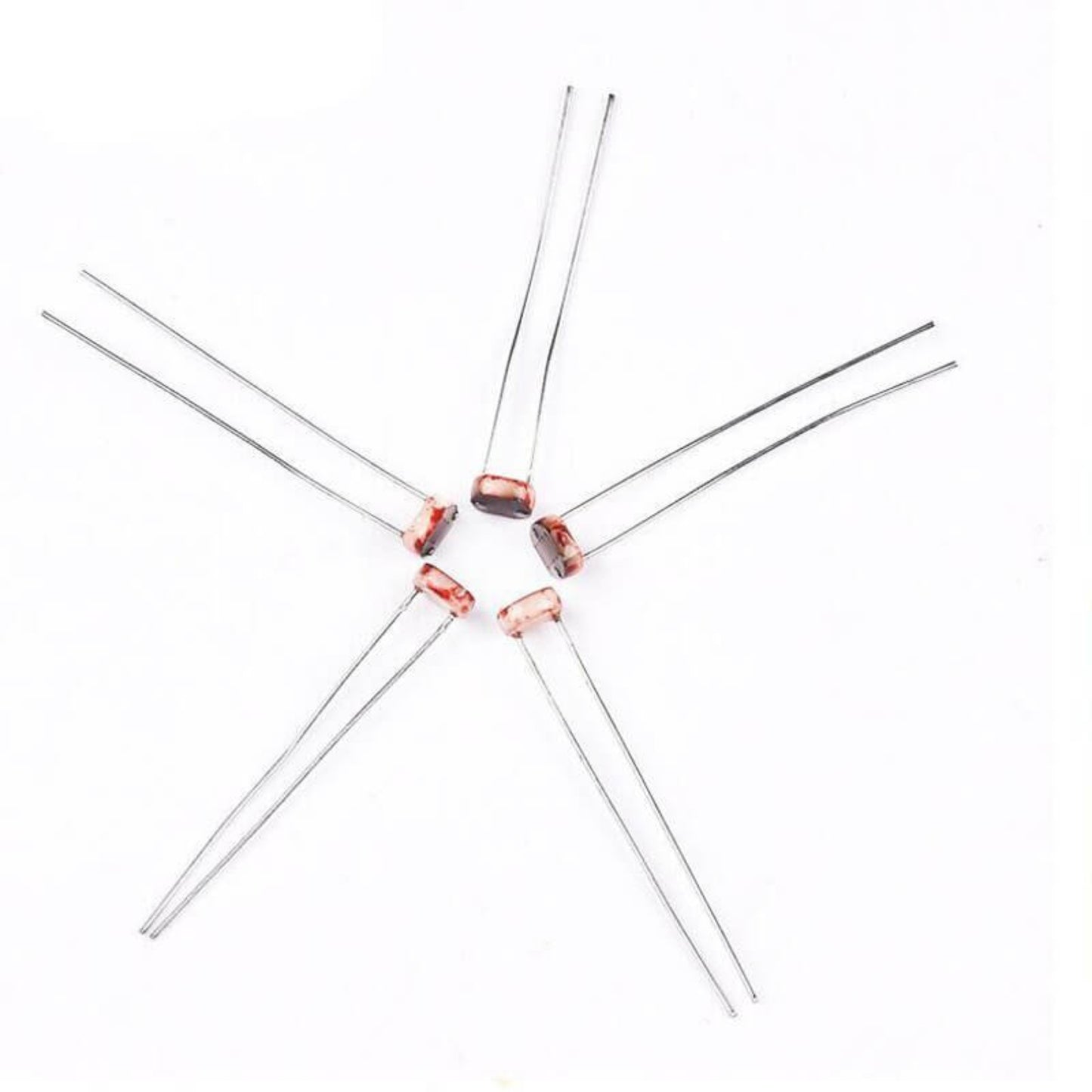 Five light-dependent resistors arranged in a star pattern on a white background, ideal for electronics projects.