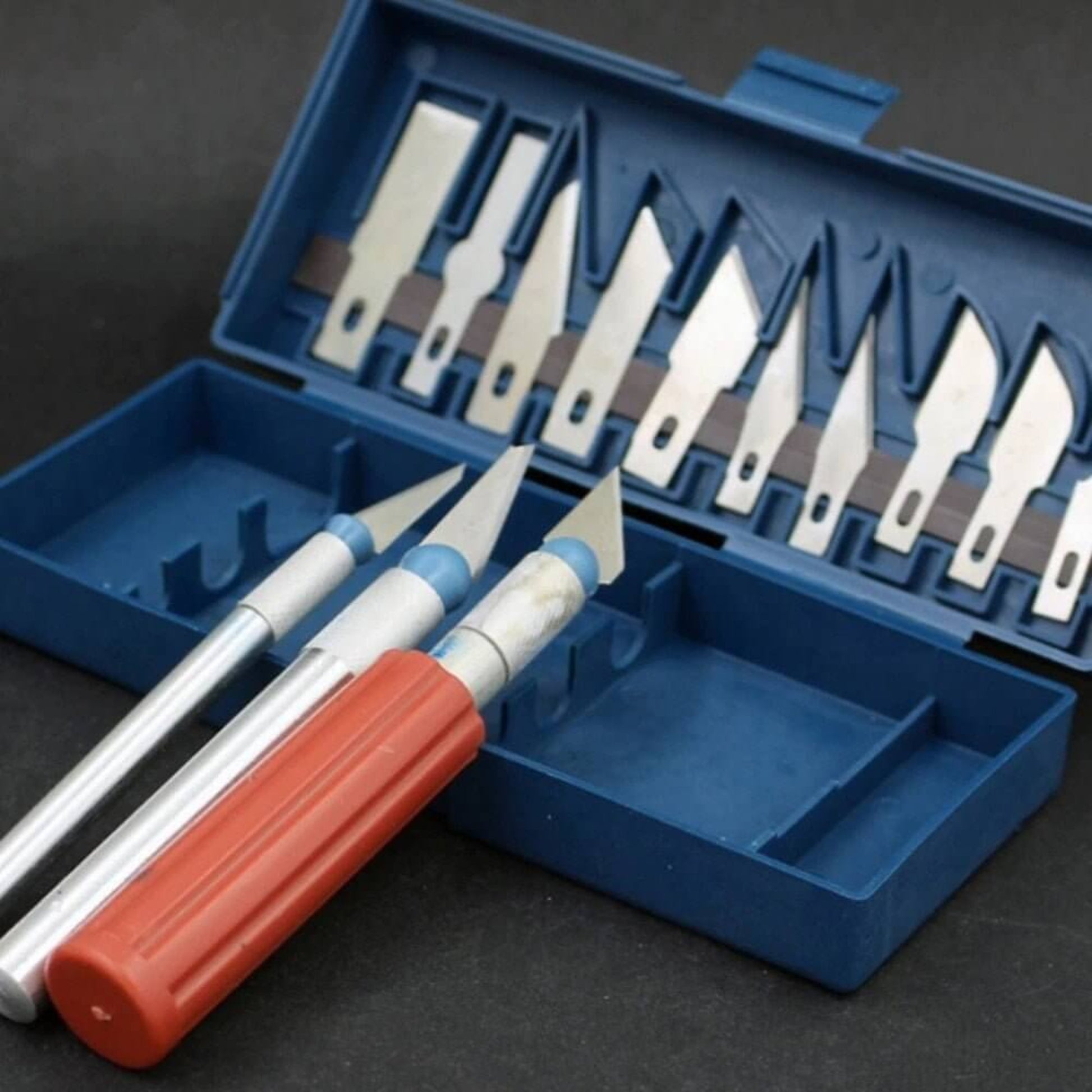 Top view of a 13pc precision knife set in its case, showcasing an array of exacto-style blades.