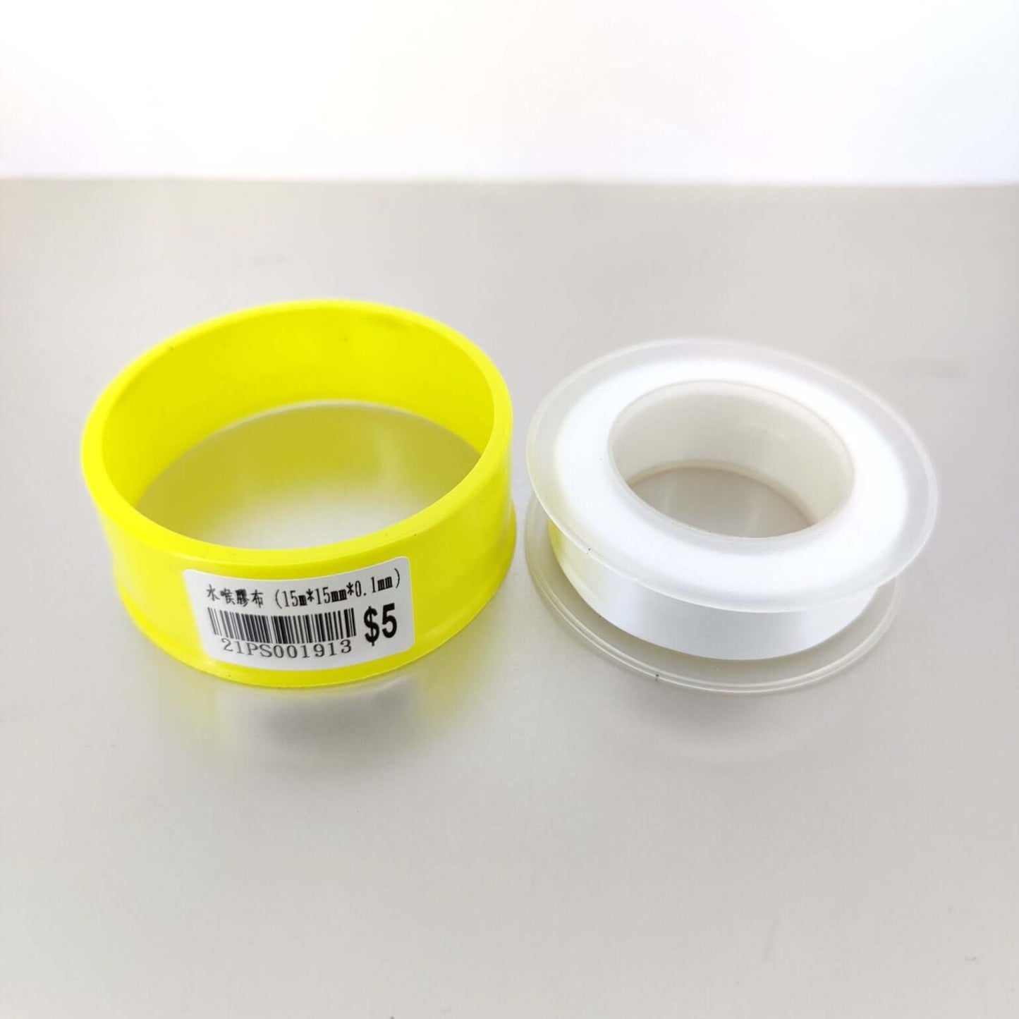 PTFE thread seal tape rolls, one yellow and one white, ideal for plumbing and gas pipe sealing.