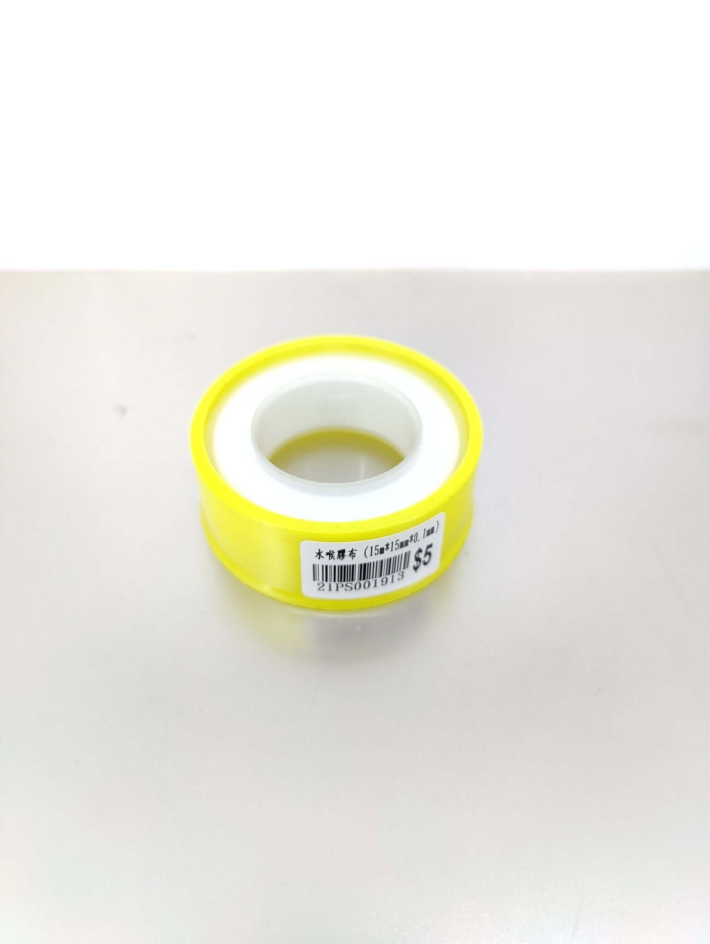 PTFE thread seal tape roll in yellow packaging, ideal for plumbing and gas pipe sealing, ensures watertight and gas-tight connections.