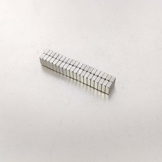 Strong mini magnets 6x4x2mm arranged in a neat row, ideal for crafts and organization.