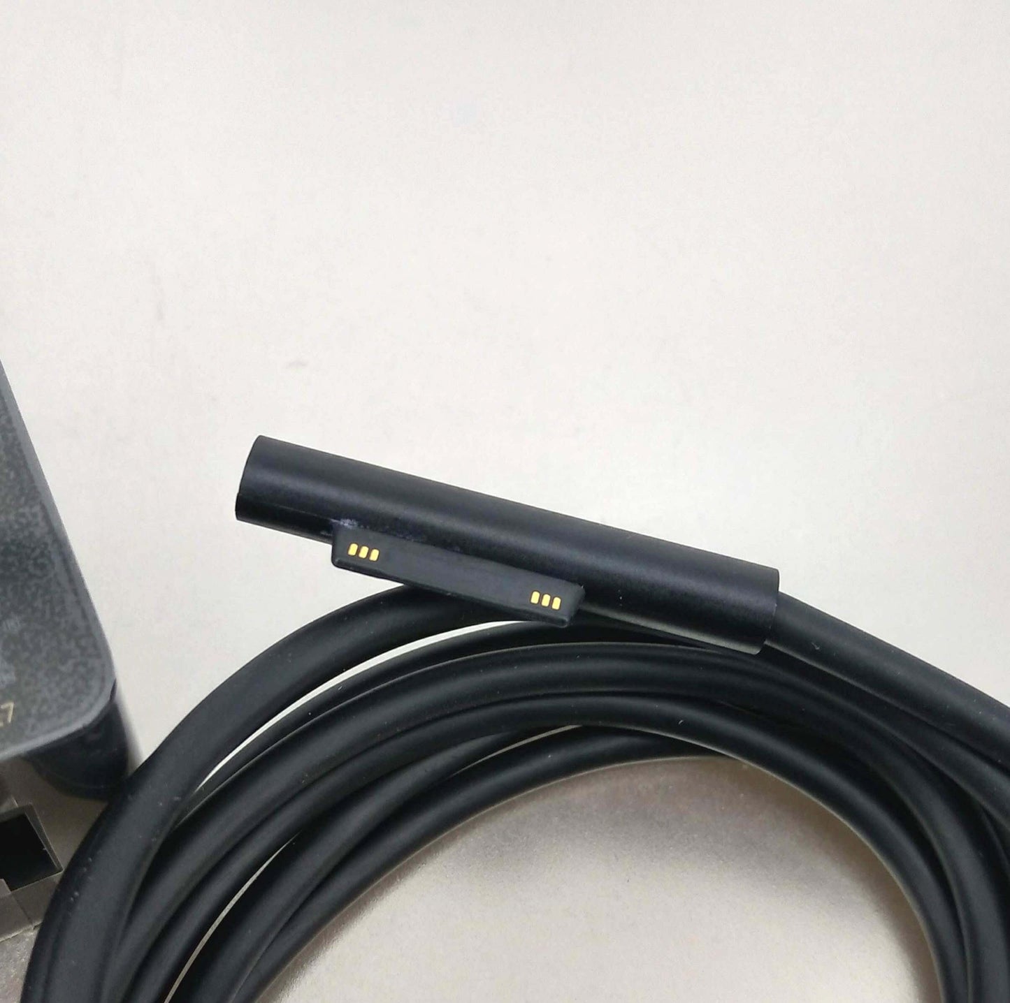 Microsoft Surface charger connector for 102W OEM charger, designed for reliable device charging.
