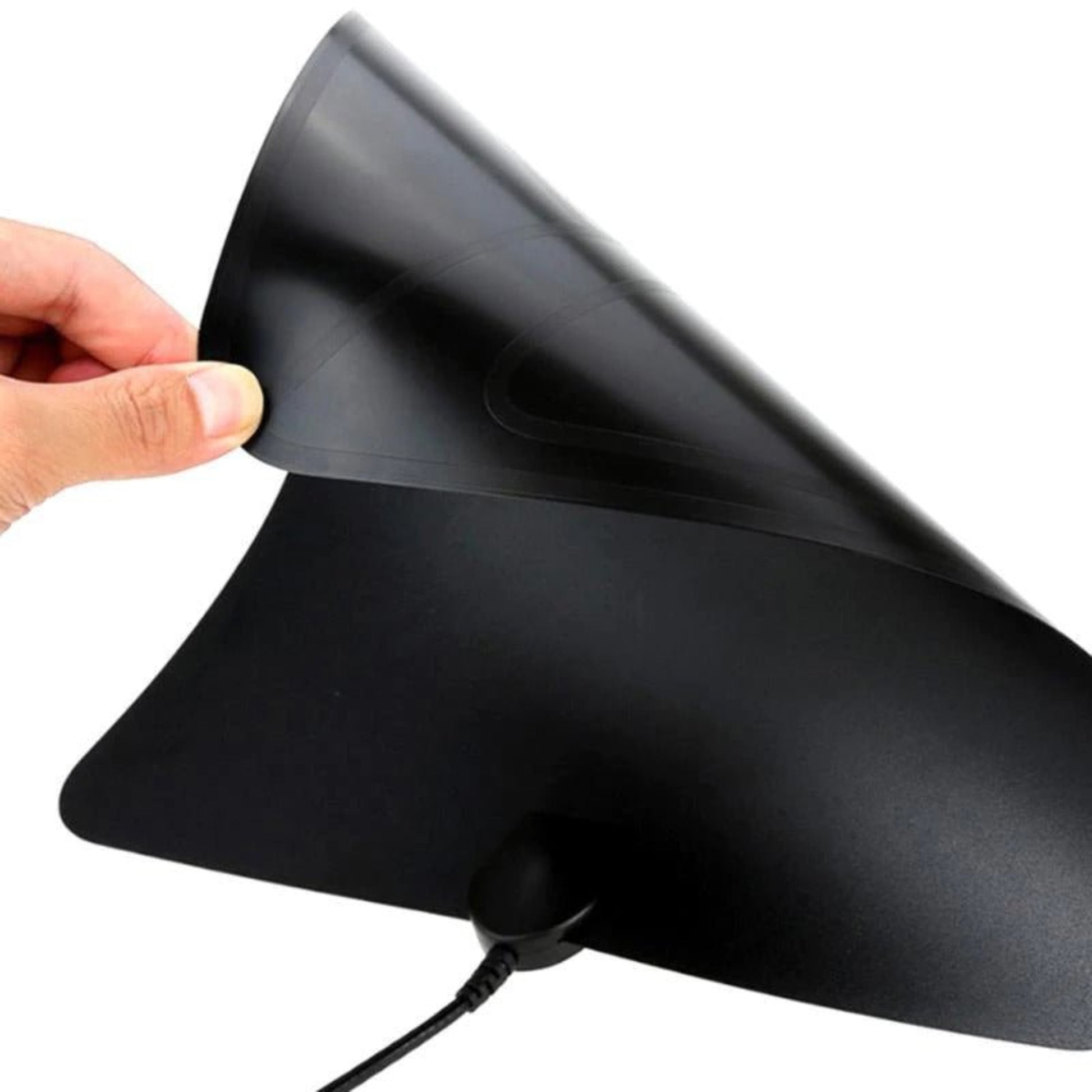 Close-up of a flexible indoor digital TV antenna being unpeel for installation.