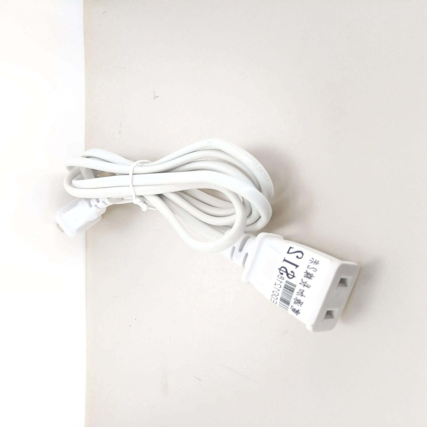 Close-up of US 2-prong male and female power extension cable ends for secure connection.
