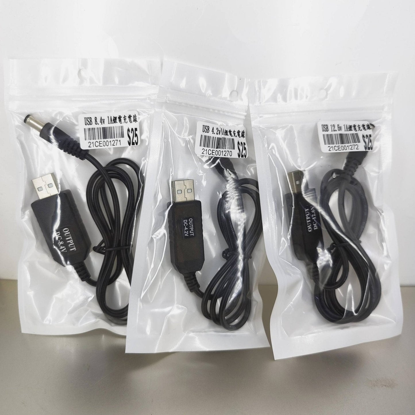 Three packs of USB charging cables for 18650 lithium battery packs, displayed in clear bags.